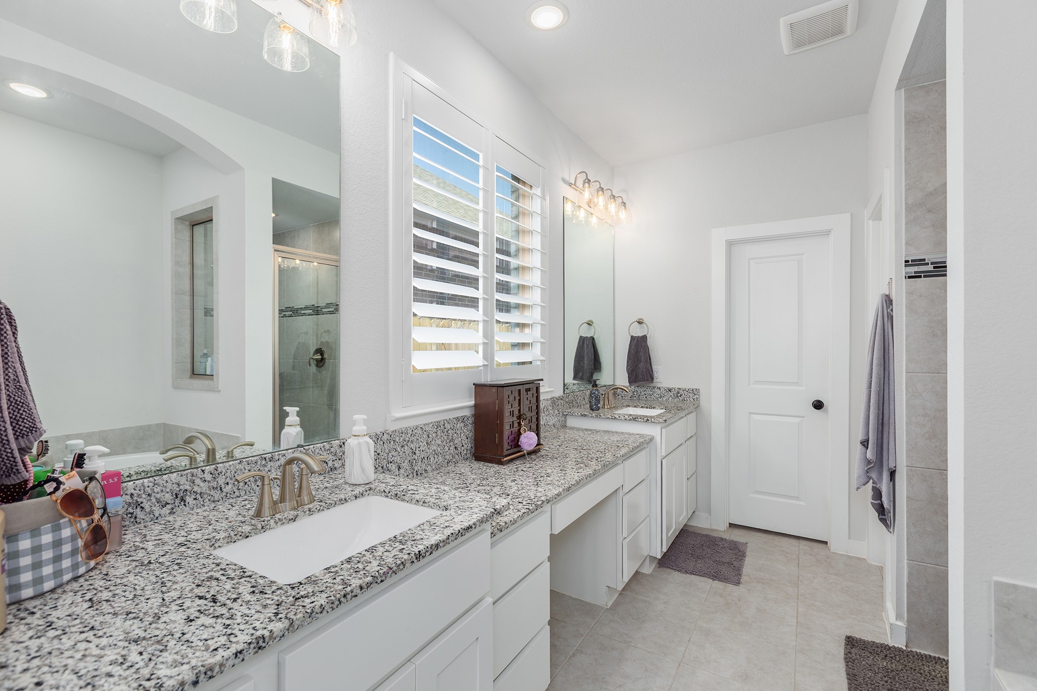 12110 Woodnote Lane Humble, TX 77346 - Photo 21 of 36 a bathroom with a granite countertop sink and a mirror