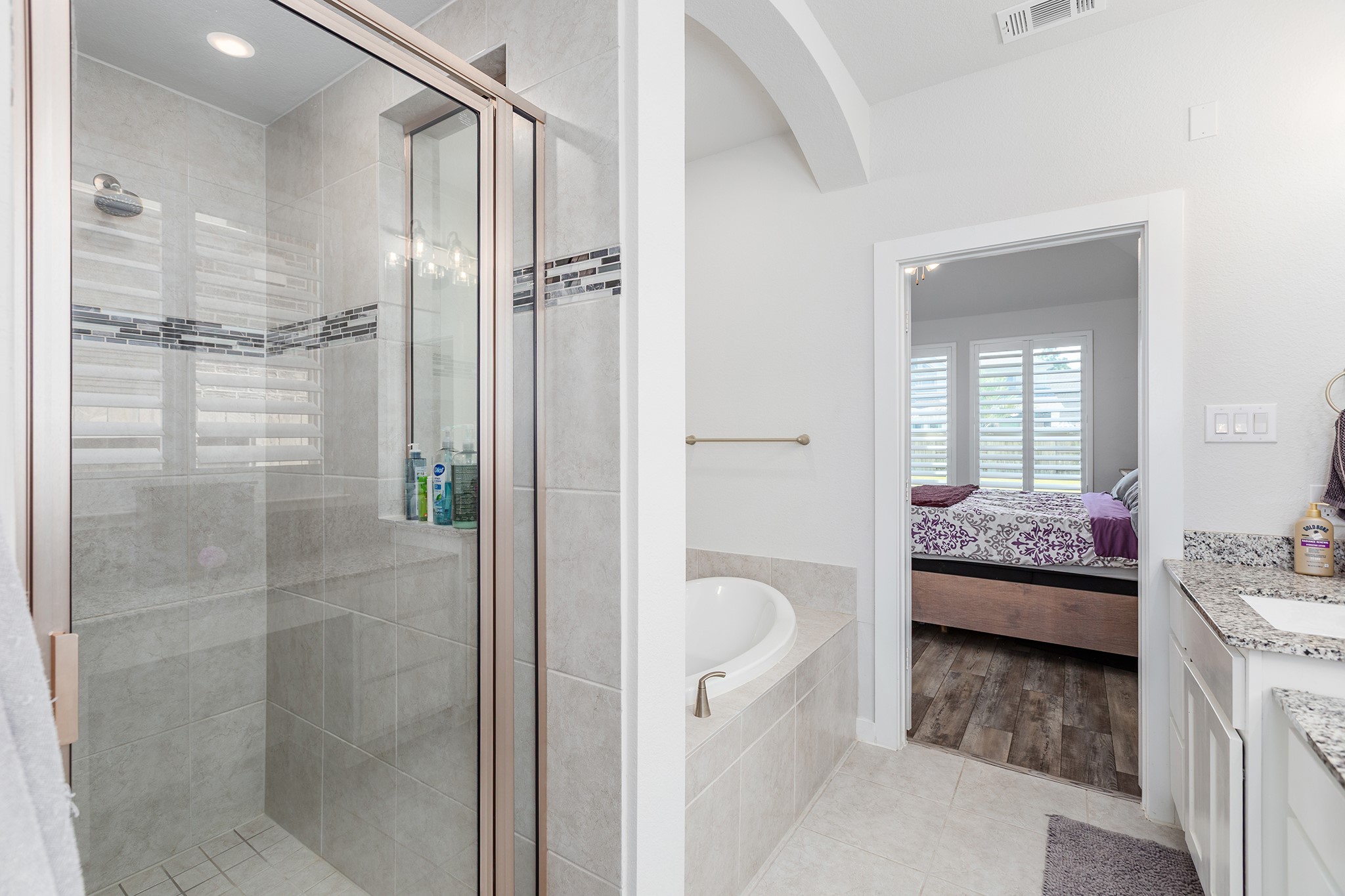 12110 Woodnote Lane Humble, TX 77346 - Photo 22 of 36 a bathroom with a granite countertop bathtub shower sink and toilet