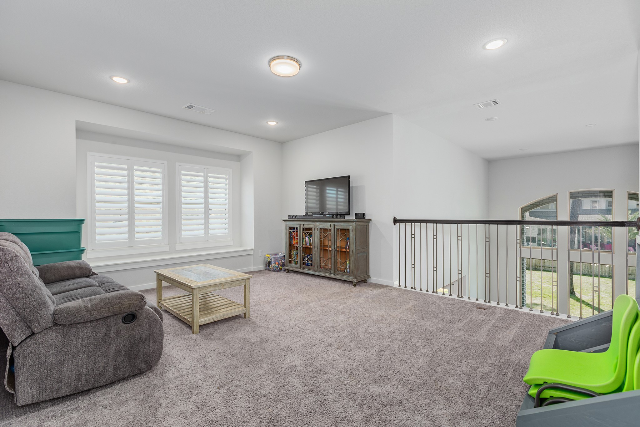 12110 Woodnote Lane Humble, TX 77346 - Photo 25 of 36 a living room with furniture and a floor to ceiling window