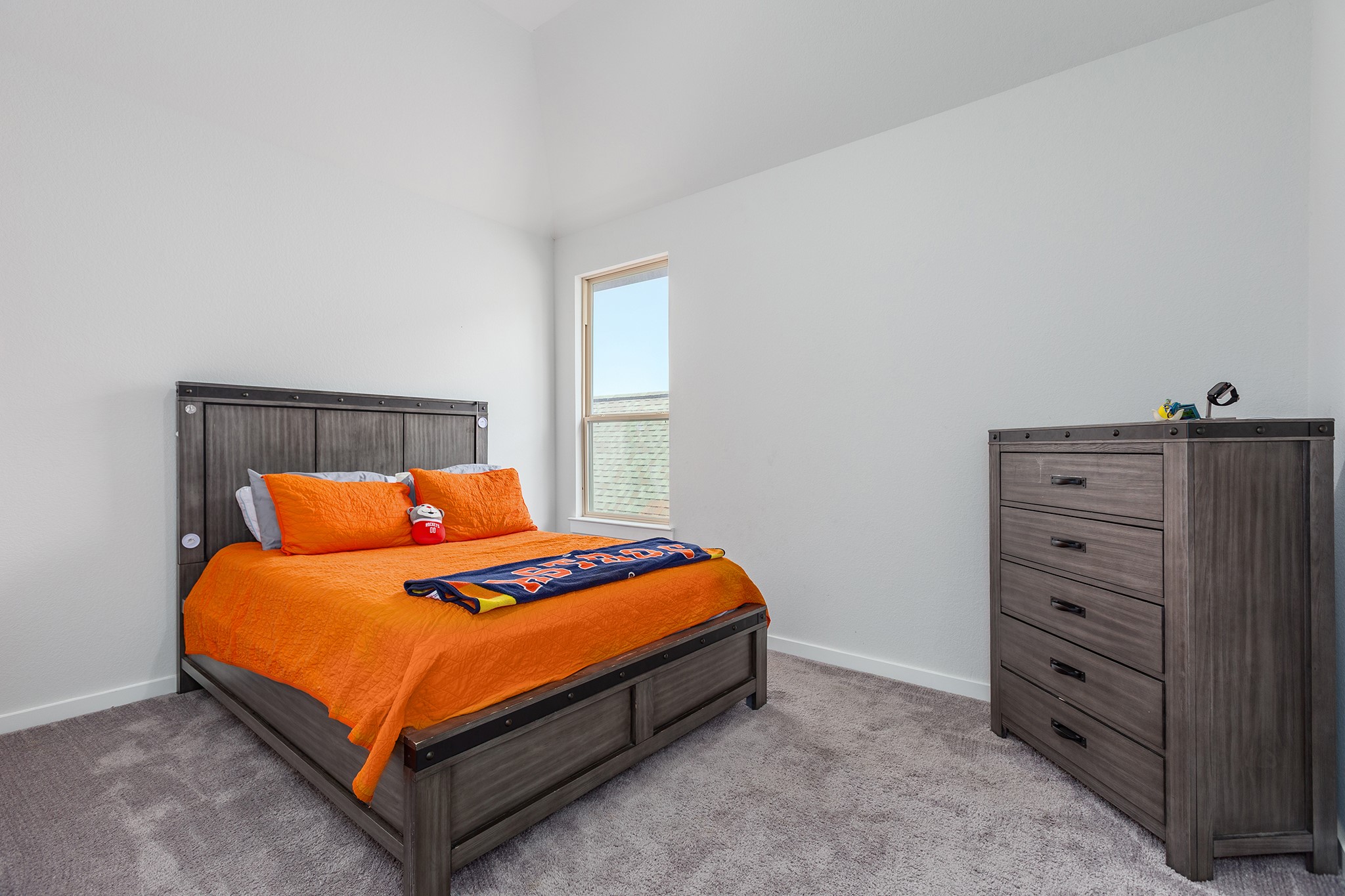 12110 Woodnote Lane Humble, TX 77346 - Photo 29 of 36 a bed sitting in a bedroom with a dresser