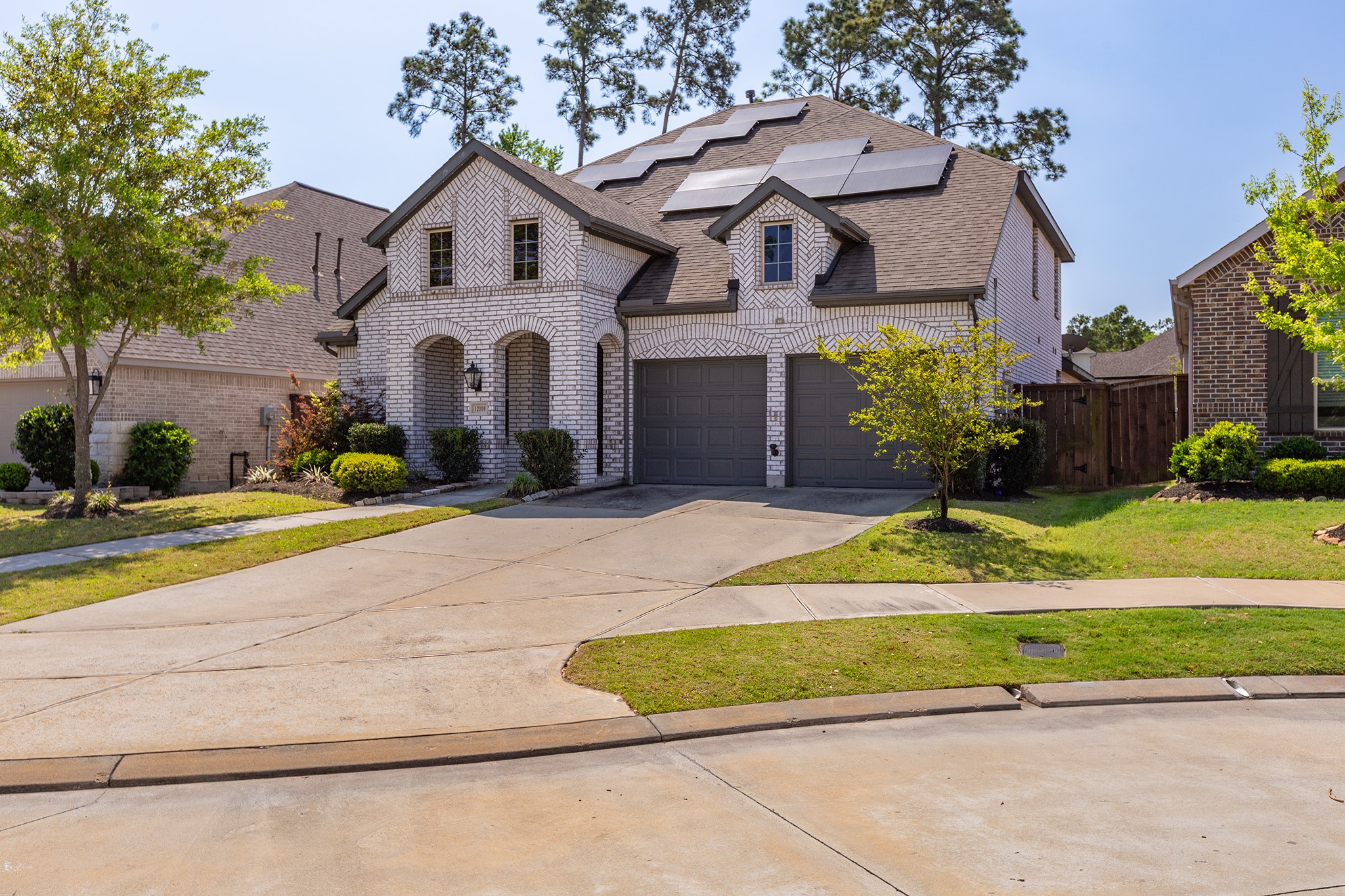 12110 Woodnote Lane Humble, TX 77346 - Photo 34 of 36 a front view of a house with a yard and potted plants