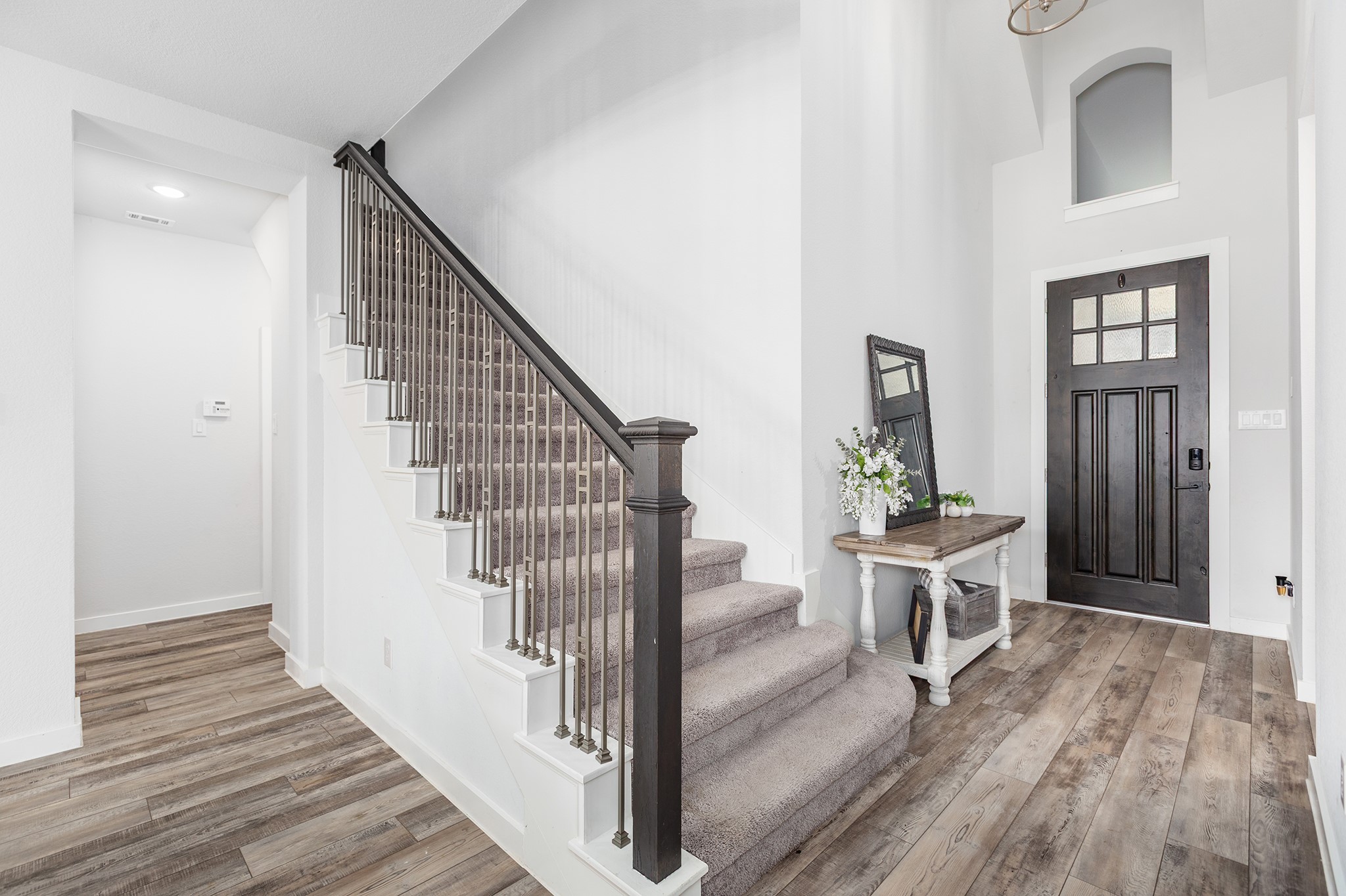 12110 Woodnote Lane Humble, TX 77346 - Photo 4 of 36 a view of a hallway with wooden floor and dining room