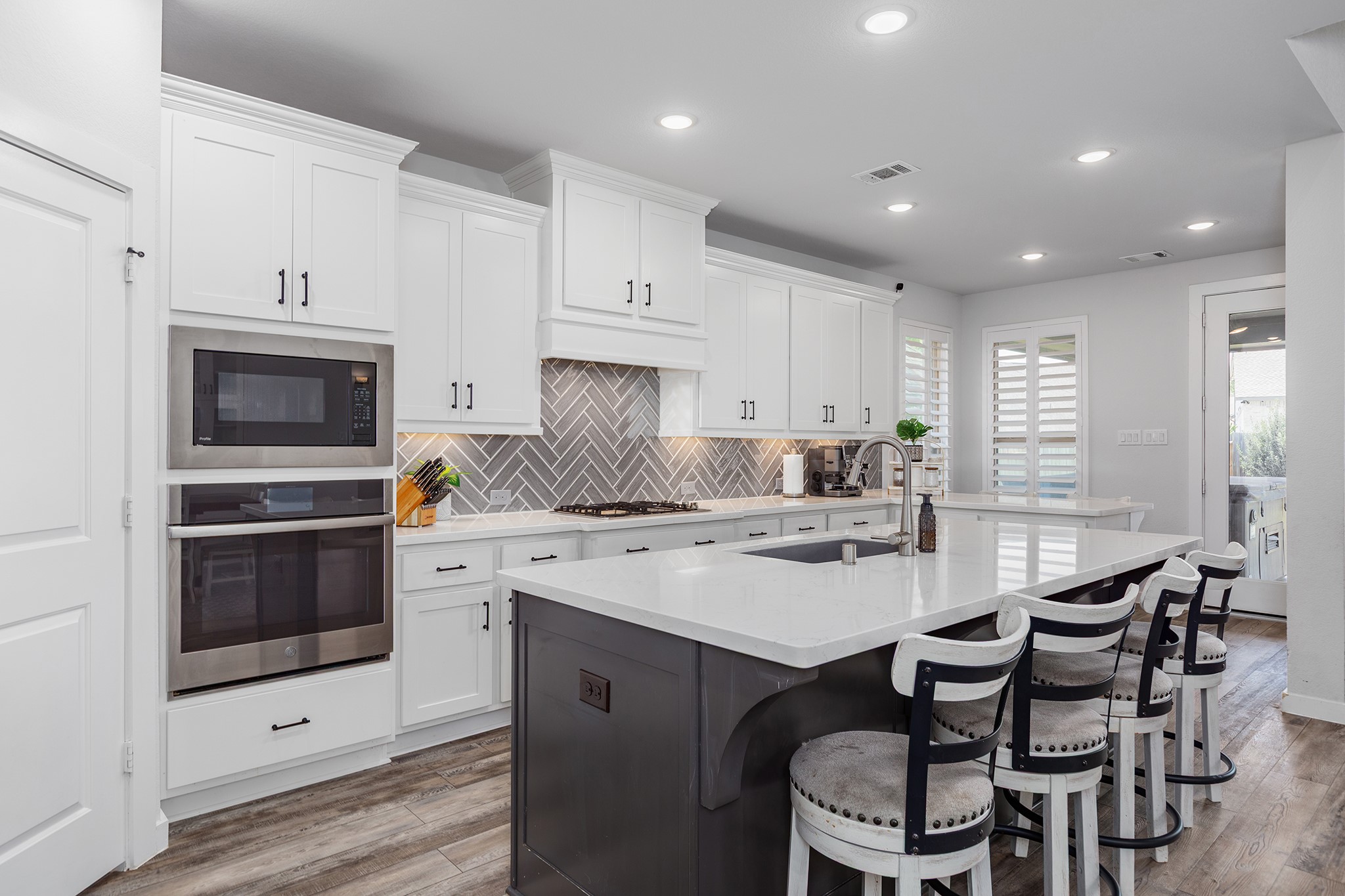 12110 Woodnote Lane Humble, TX 77346 - Photo 5 of 36 a kitchen with a stove a sink a dining table and chairs