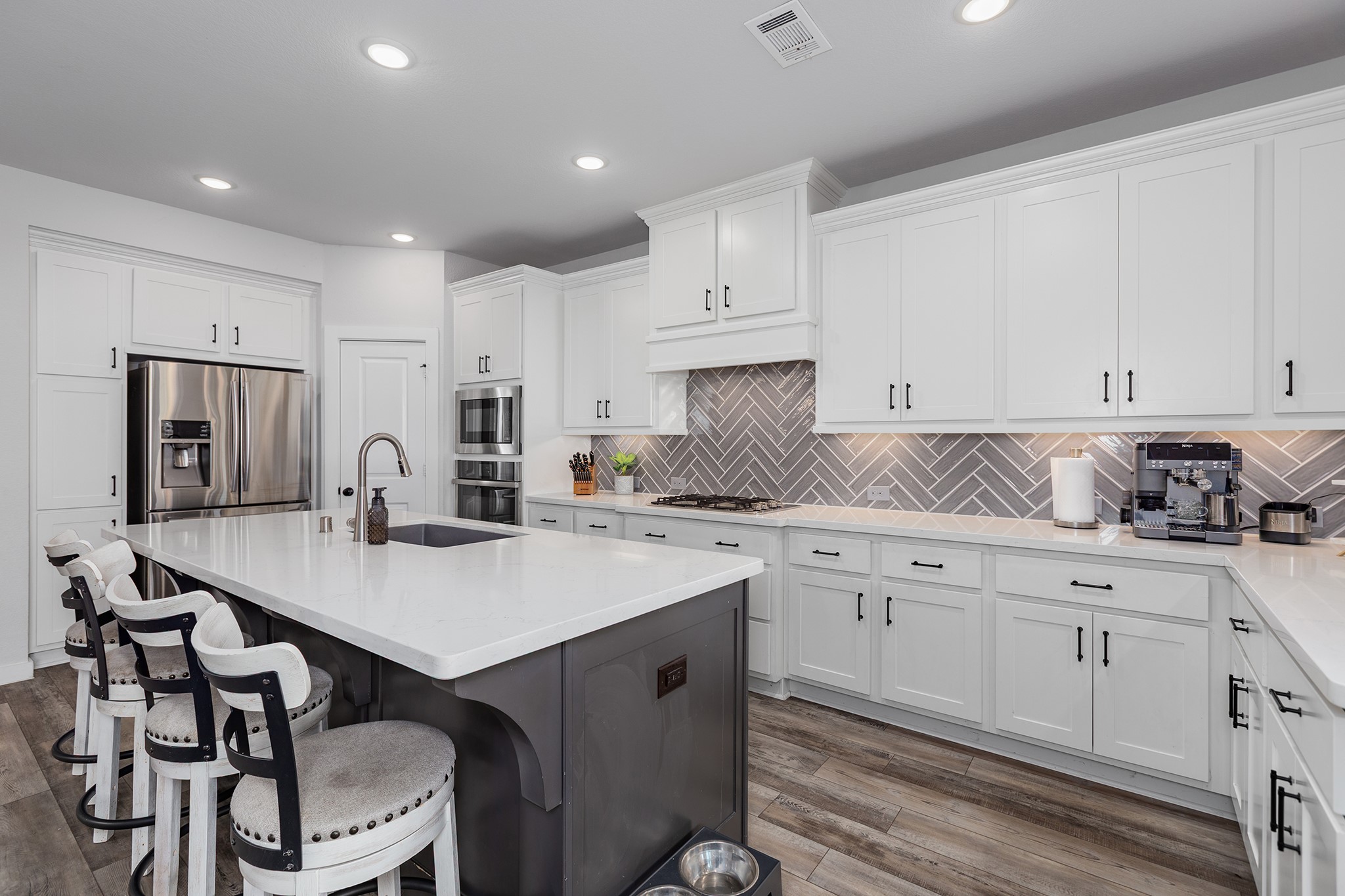 12110 Woodnote Lane Humble, TX 77346 - Photo 6 of 36 a kitchen with a sink cabinets and wooden floor