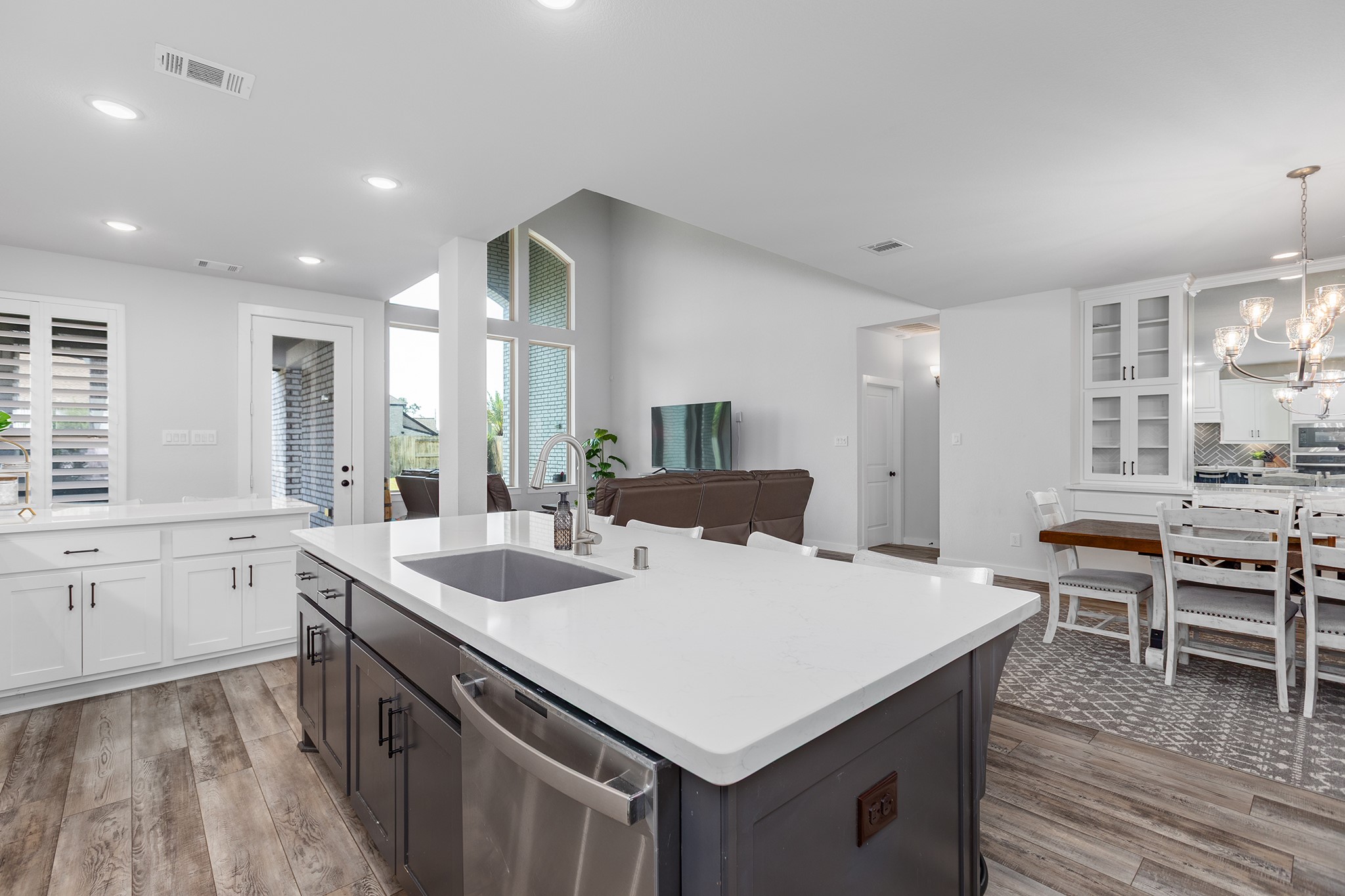 12110 Woodnote Lane Humble, TX 77346 - Photo 7 of 36 a kitchen that has a sink a table and chairs in it