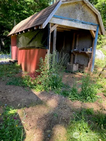 a view of a wooden house with a yard