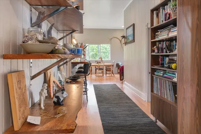 a view of entryway and hall with wooden floor
