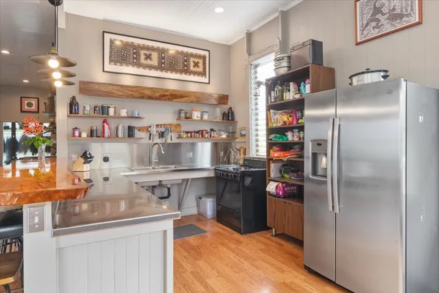 a kitchen with stainless steel appliances granite countertop a refrigerator and a sink