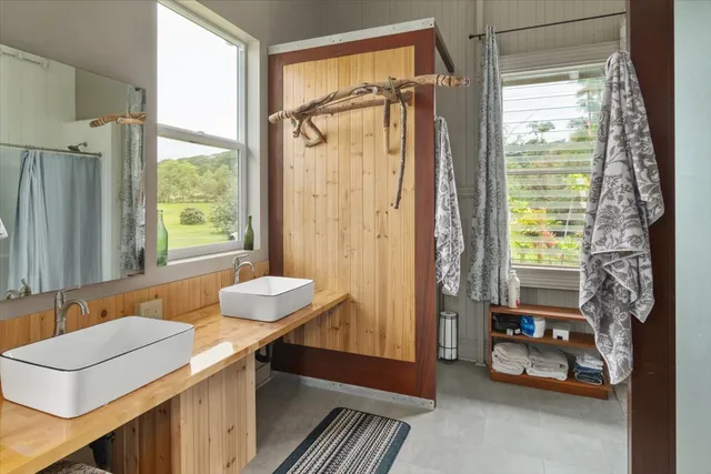 a bathroom with a sink mirror and a bathtub