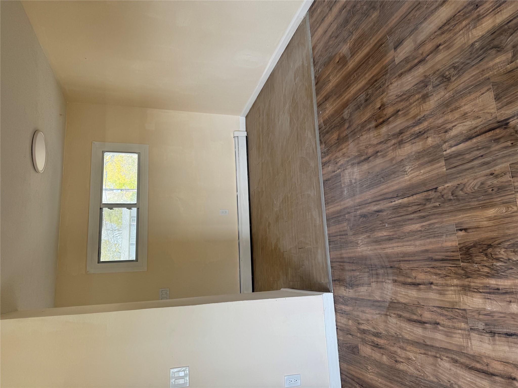 1 Pine Road Middle Island, NY 11953 - Photo 12 of 21 Empty room featuring baseboards, baseboard heating, and wood finished floors