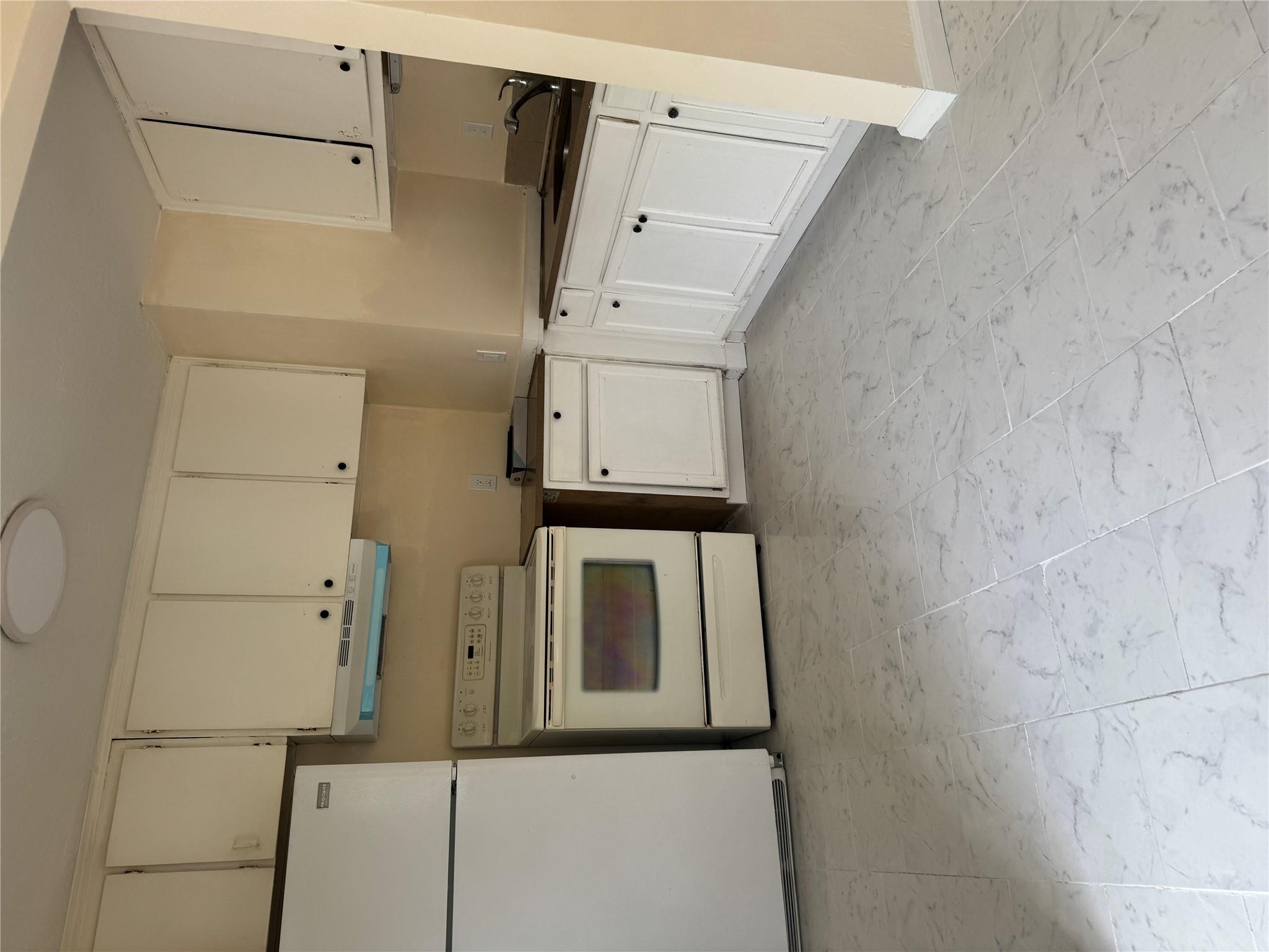1 Pine Road Middle Island, NY 11953 - Photo 16 of 21 Kitchen featuring stove, fridge, extractor fan, and marble finish floor