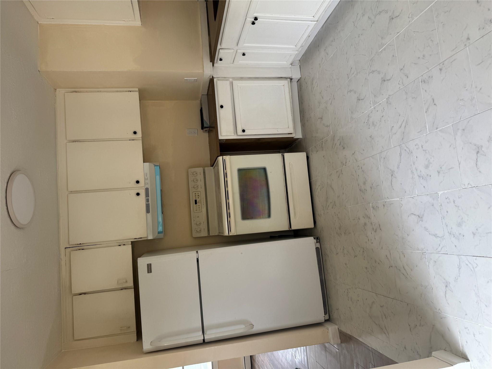 1 Pine Road Middle Island, NY 11953 - Photo 4 of 21 Kitchen with white electric stove, range hood, refrigerator, marble finish floor, and cream cabinetry