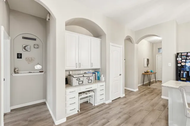 a view of kitchen with kitchen island wooden floors appliances