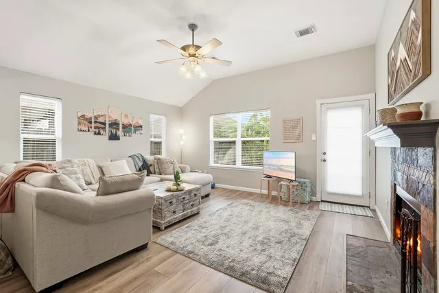 a living room with furniture and a fireplace