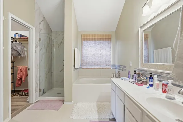 a bathroom with a double vanity sink mirror and toilet