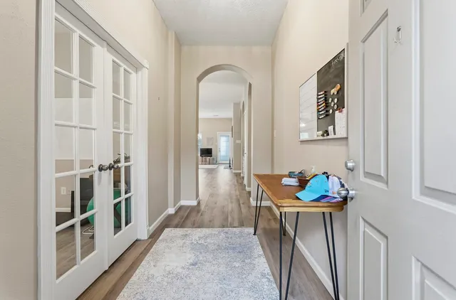 a hallway with toys and wooden floor
