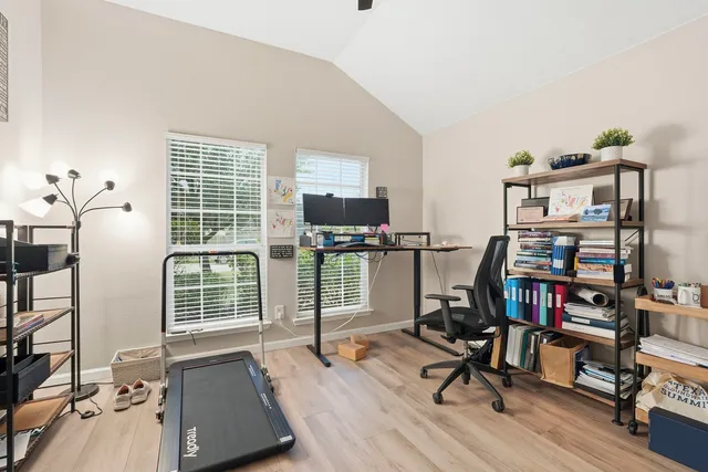 a view of a workspace with furniture and a window