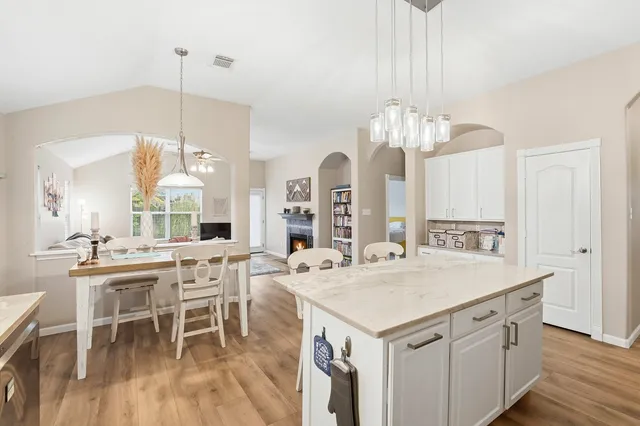 a view of a dining table chairs and chandelier