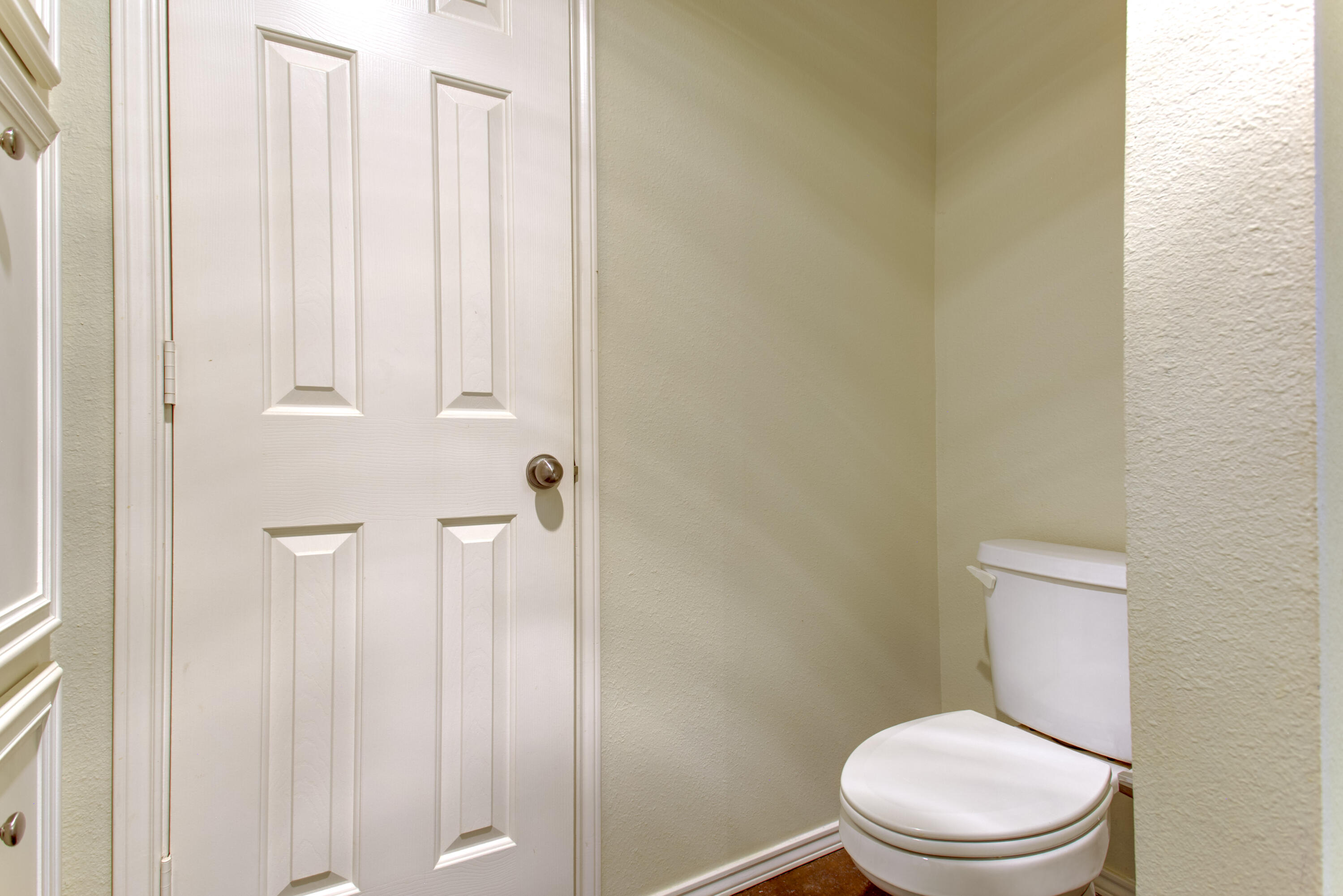 6804 7th Street Lubbock, TX 79416 - Photo 19 of 42 a white toilet sitting next to a shower