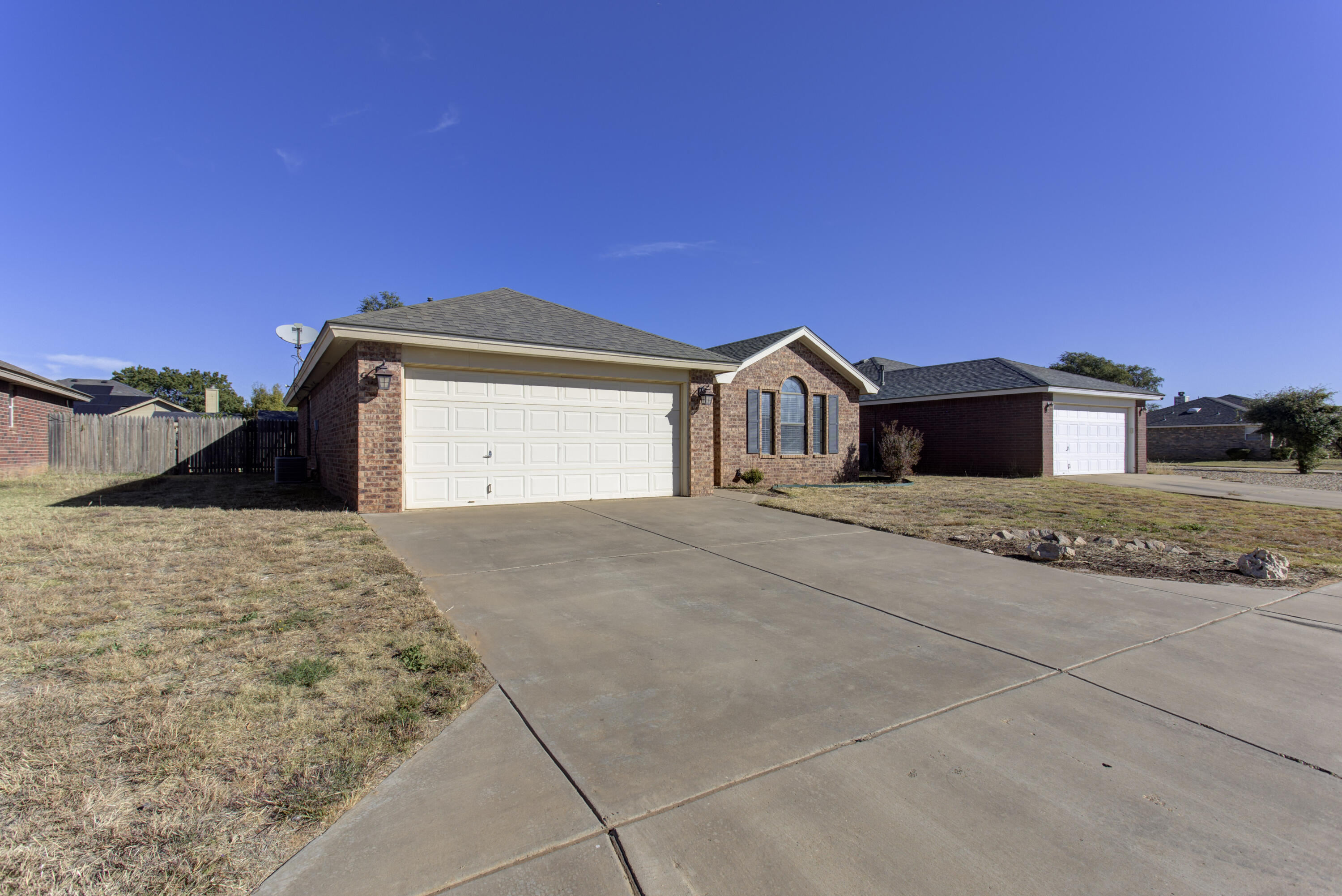 6804 7th Street Lubbock, TX 79416 - Photo 2 of 42 a front view of a house with a yard