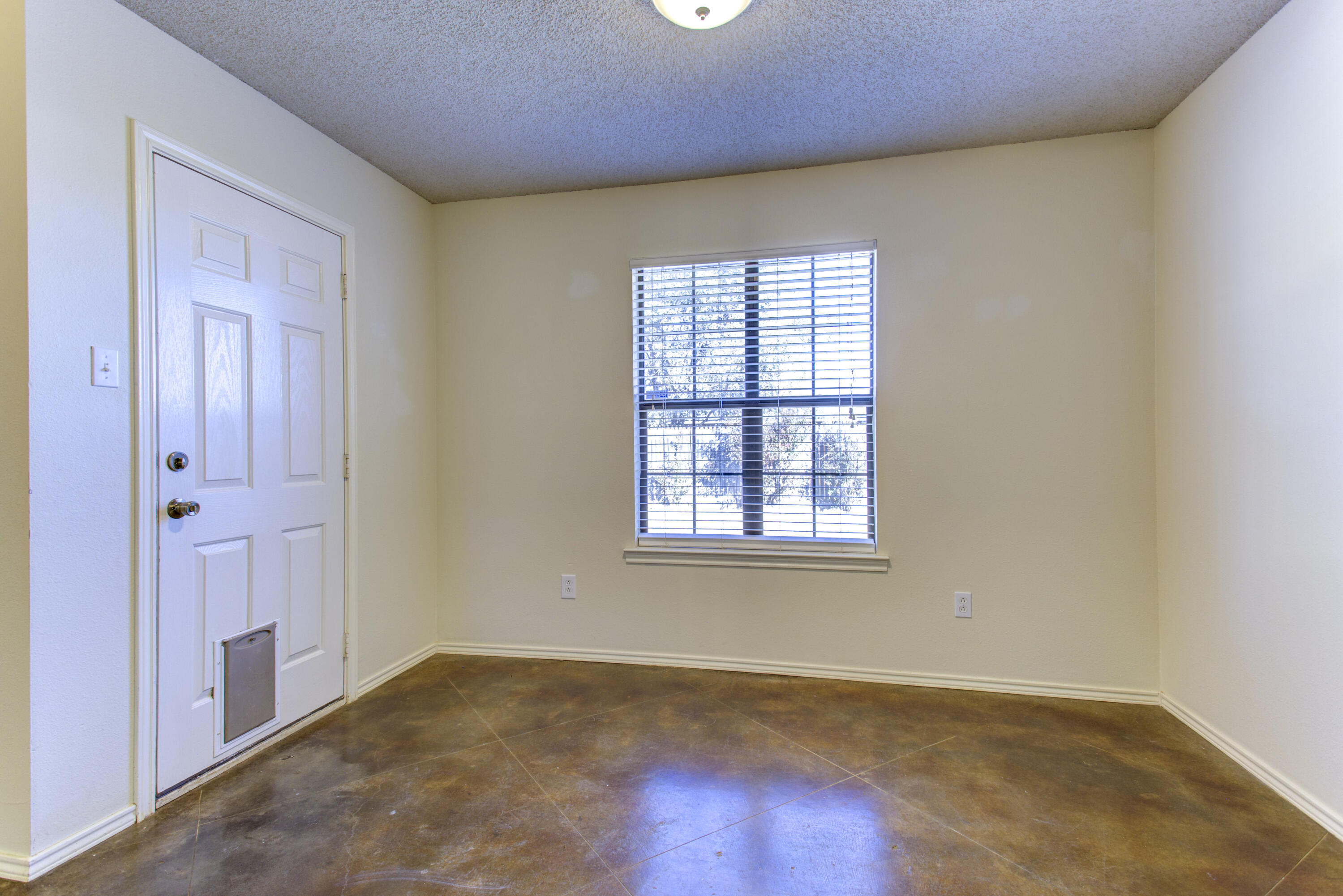 6804 7th Street Lubbock, TX 79416 - Photo 32 of 42 an empty room with wooden floor and windows