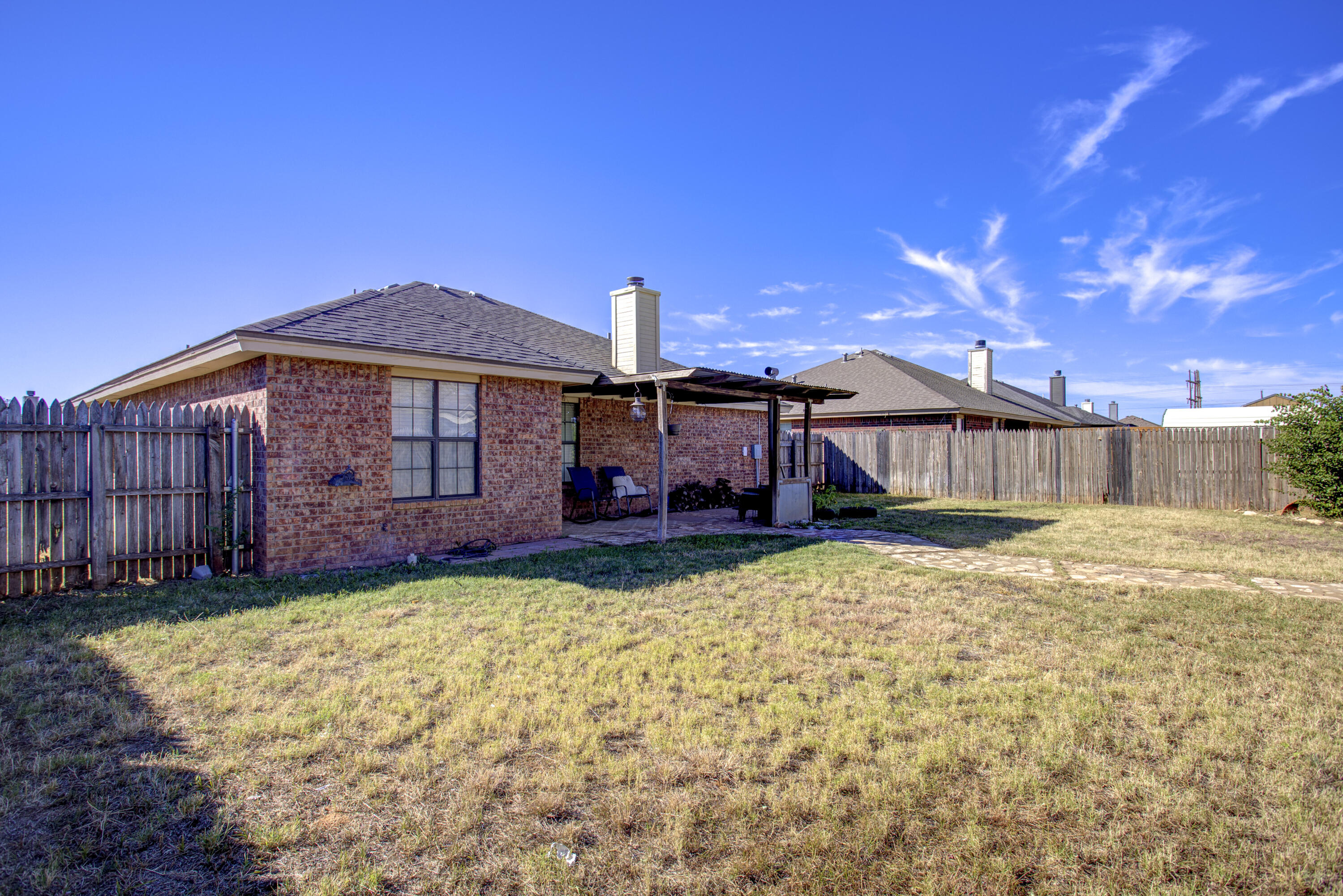 6804 7th Street Lubbock, TX 79416 - Photo 34 of 42 a view of a house with backyard and sitting area