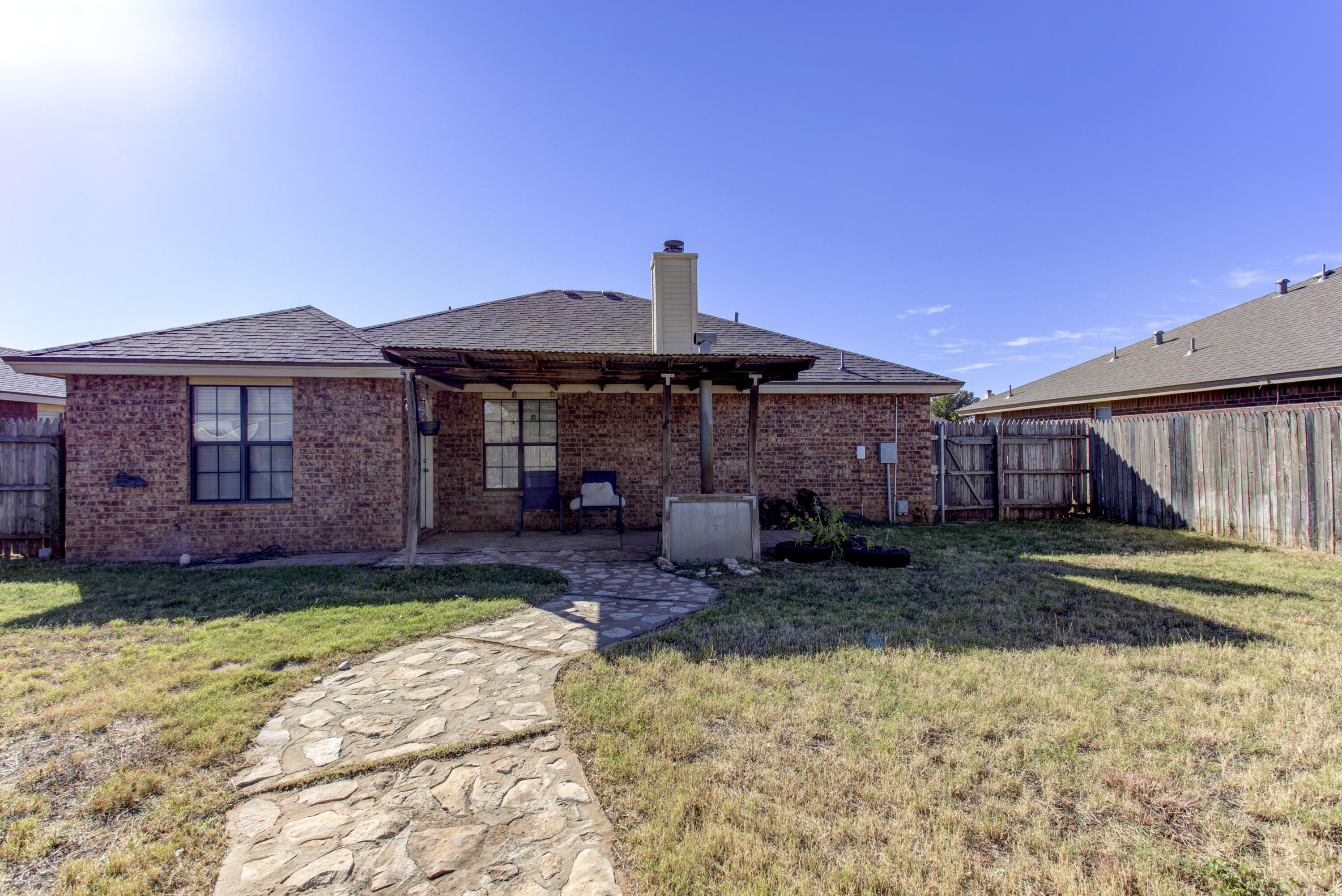 6804 7th Street Lubbock, TX 79416 - Photo 35 of 42 a front view of a house with a garden and porch