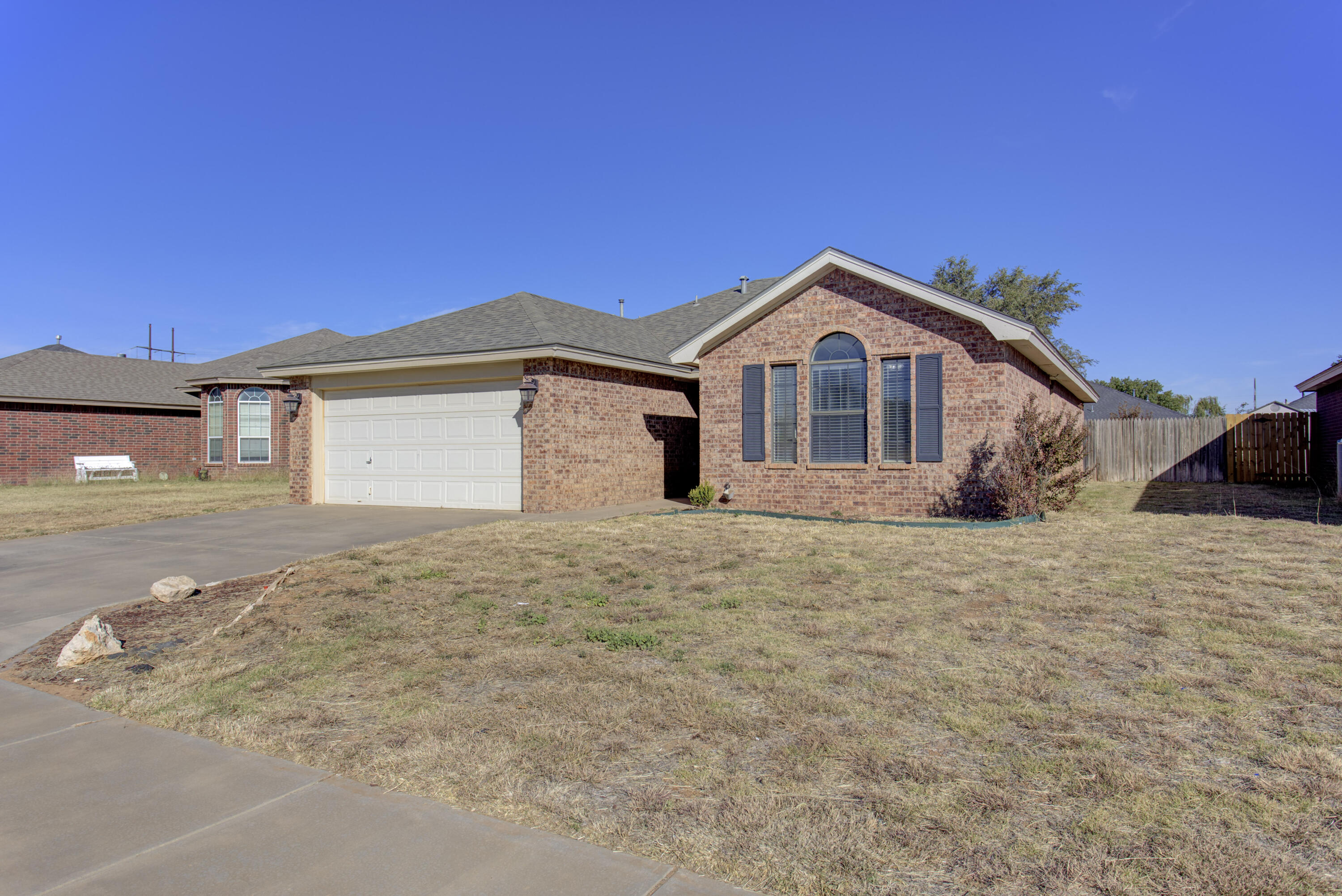 6804 7th Street Lubbock, TX 79416 - Photo 41 of 42 a front view of a house with a yard