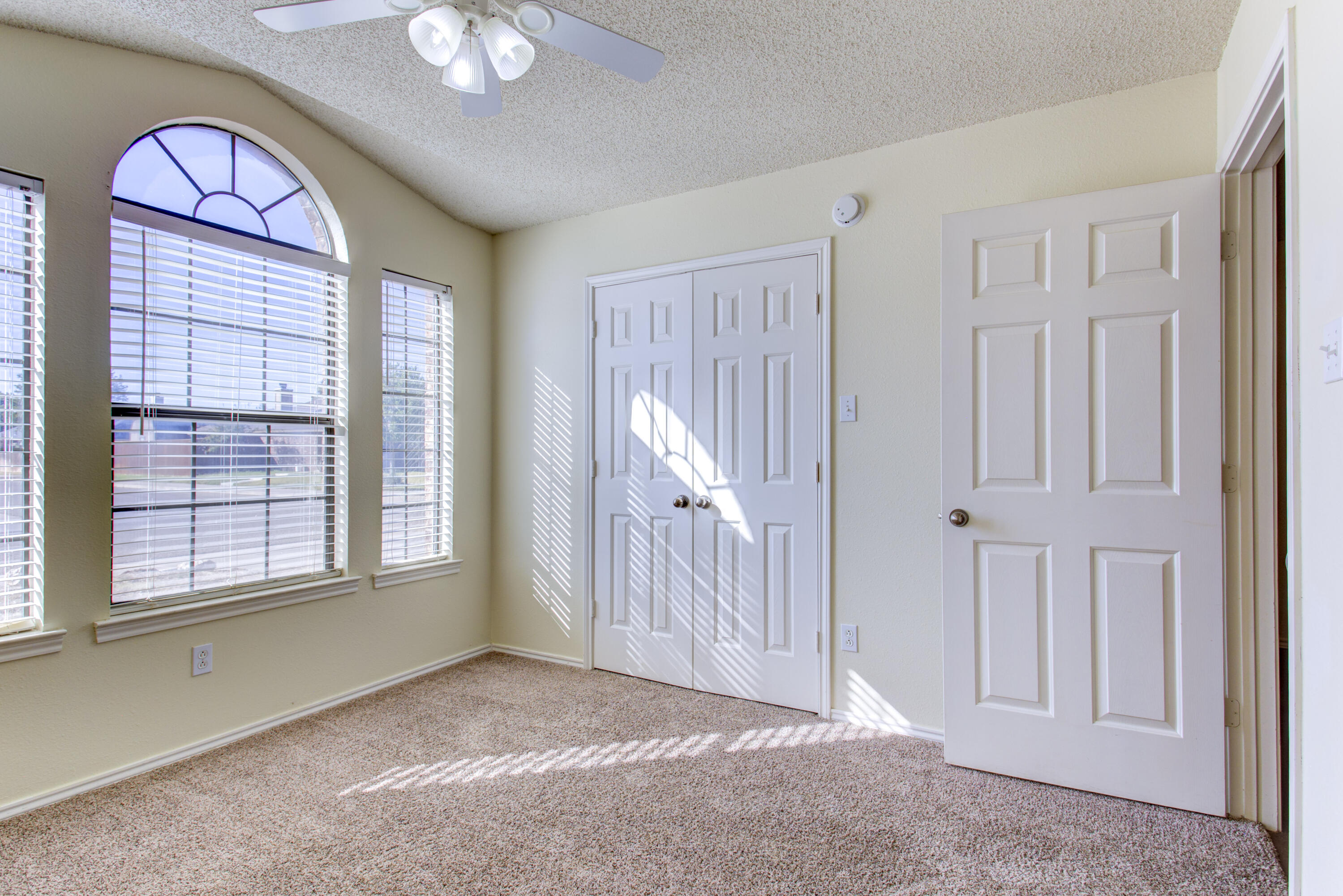 6804 7th Street Lubbock, TX 79416 - Photo 9 of 42 an empty room with windows cabinet and a livingroom
