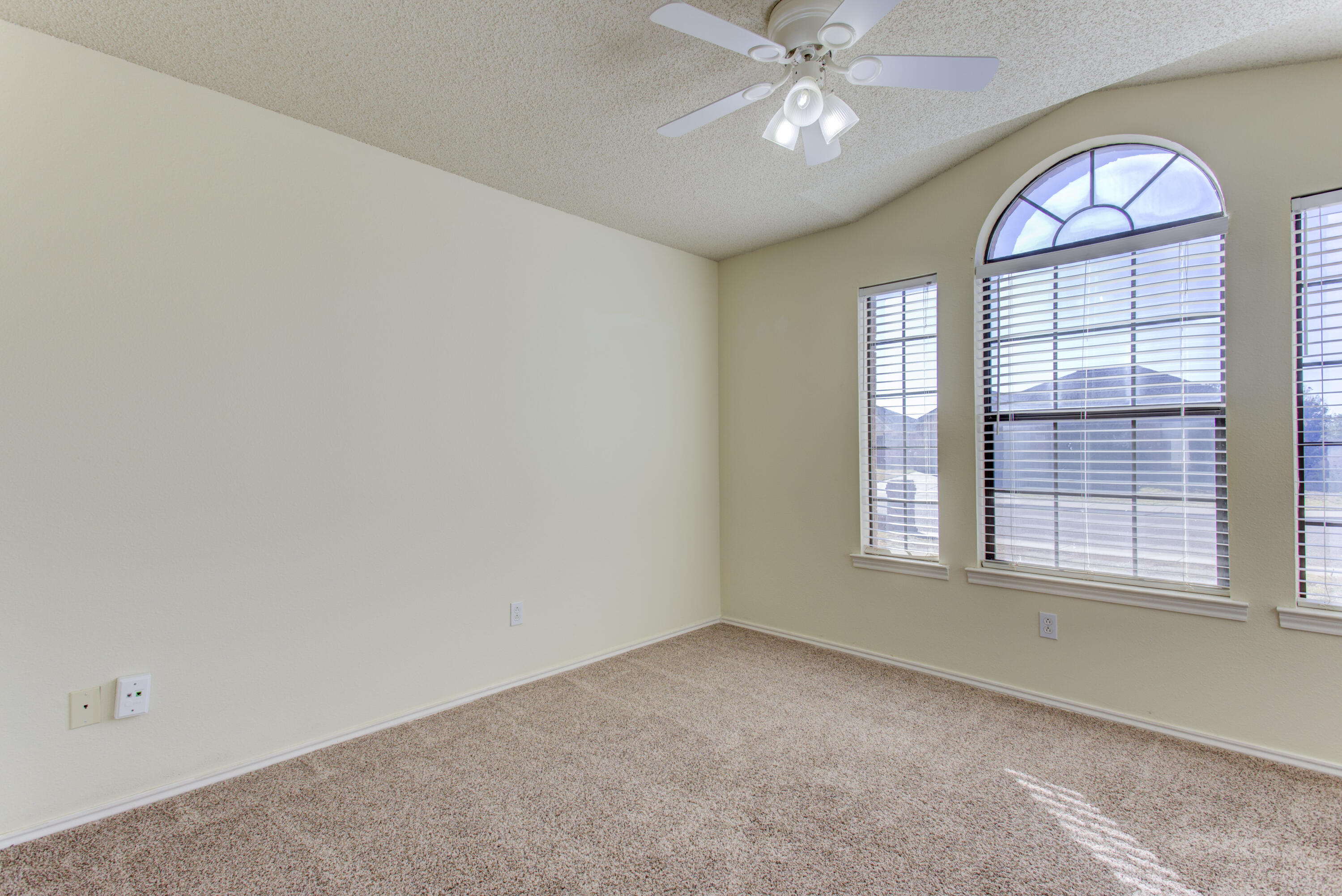 6804 7th Street Lubbock, TX 79416 - Photo 10 of 42 an empty room with a window and a chandelier