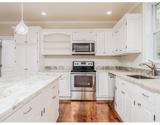 a kitchen with granite countertop a sink cabinets and stainless steel appliances