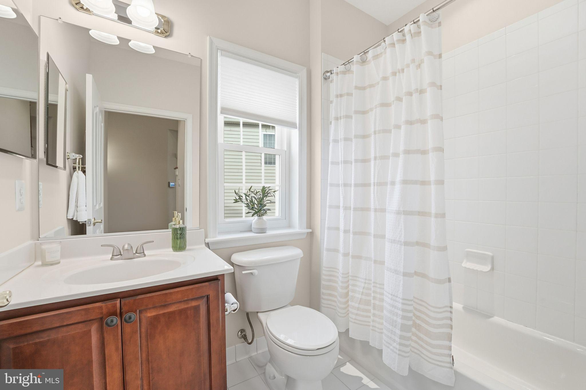 13141 Triple Crown Loop Gainesville, VA 20155 - Photo 12 of 68 a bathroom with a sink a toilet a mirror and shower