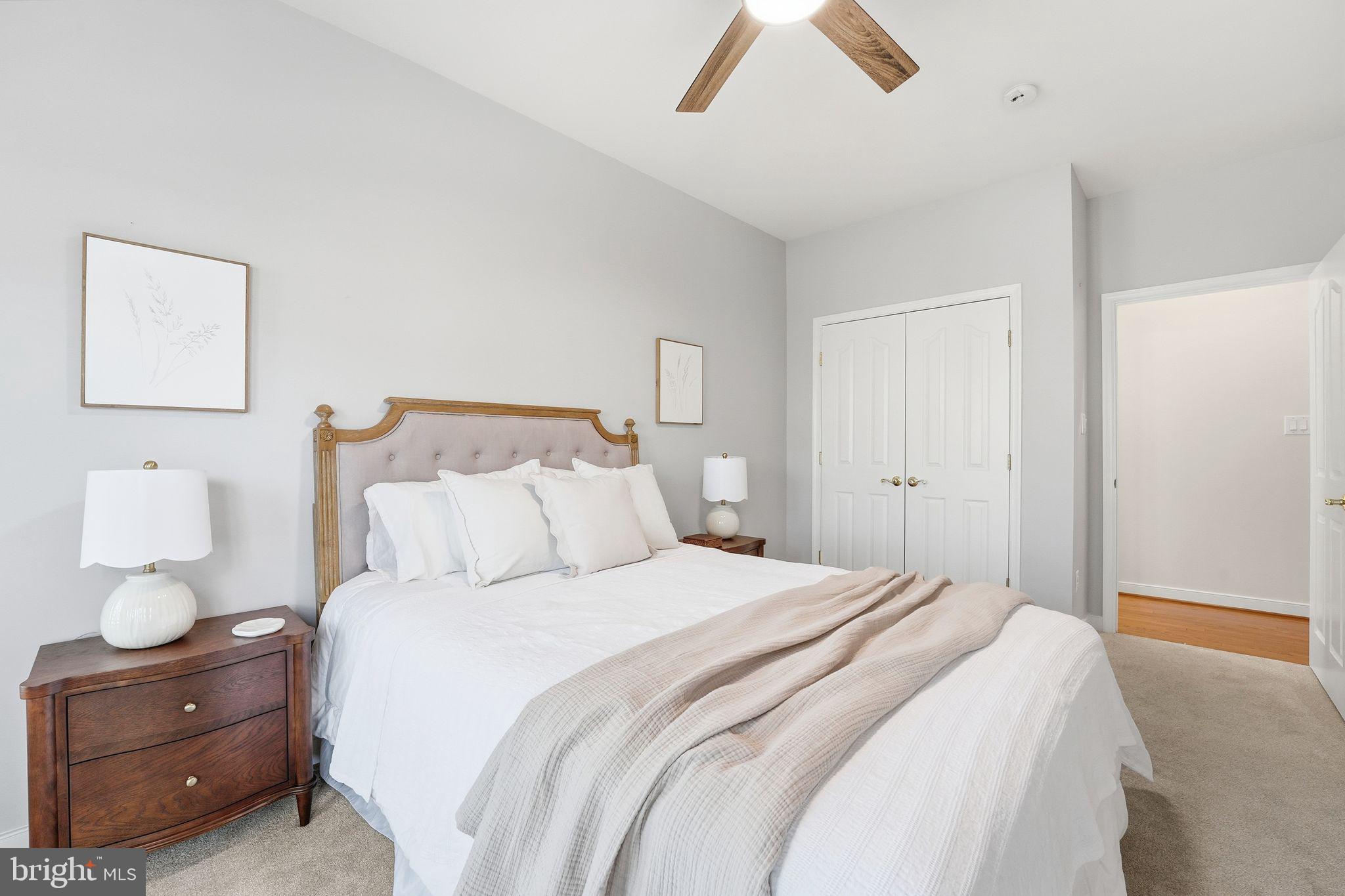 13141 Triple Crown Loop Gainesville, VA 20155 - Photo 14 of 68 a bedroom with a bed and a lamp on dresser