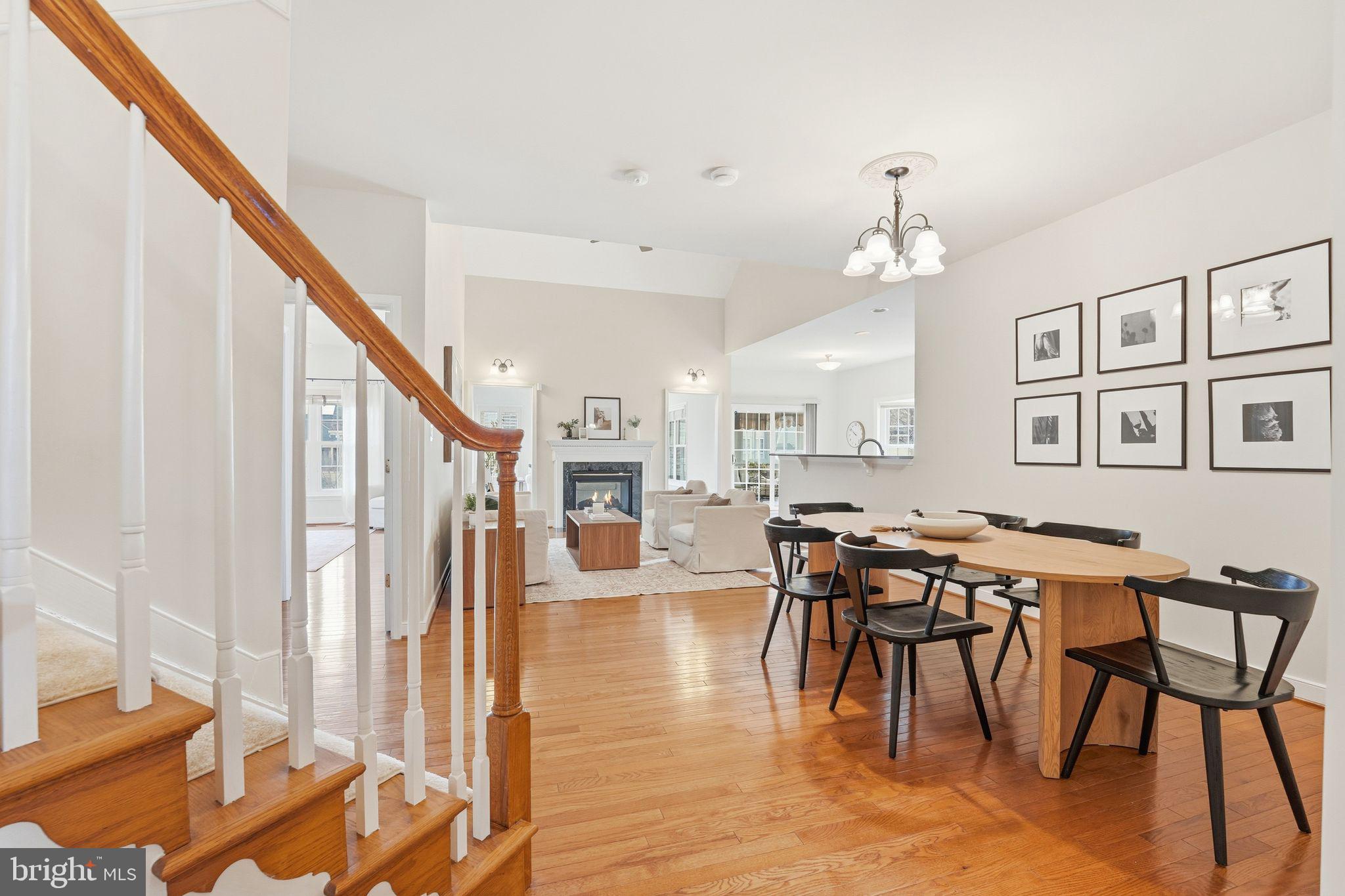 13141 Triple Crown Loop Gainesville, VA 20155 - Photo 66 of 68 a view of a dining room and livingroom with furniture wooden floor and a rug