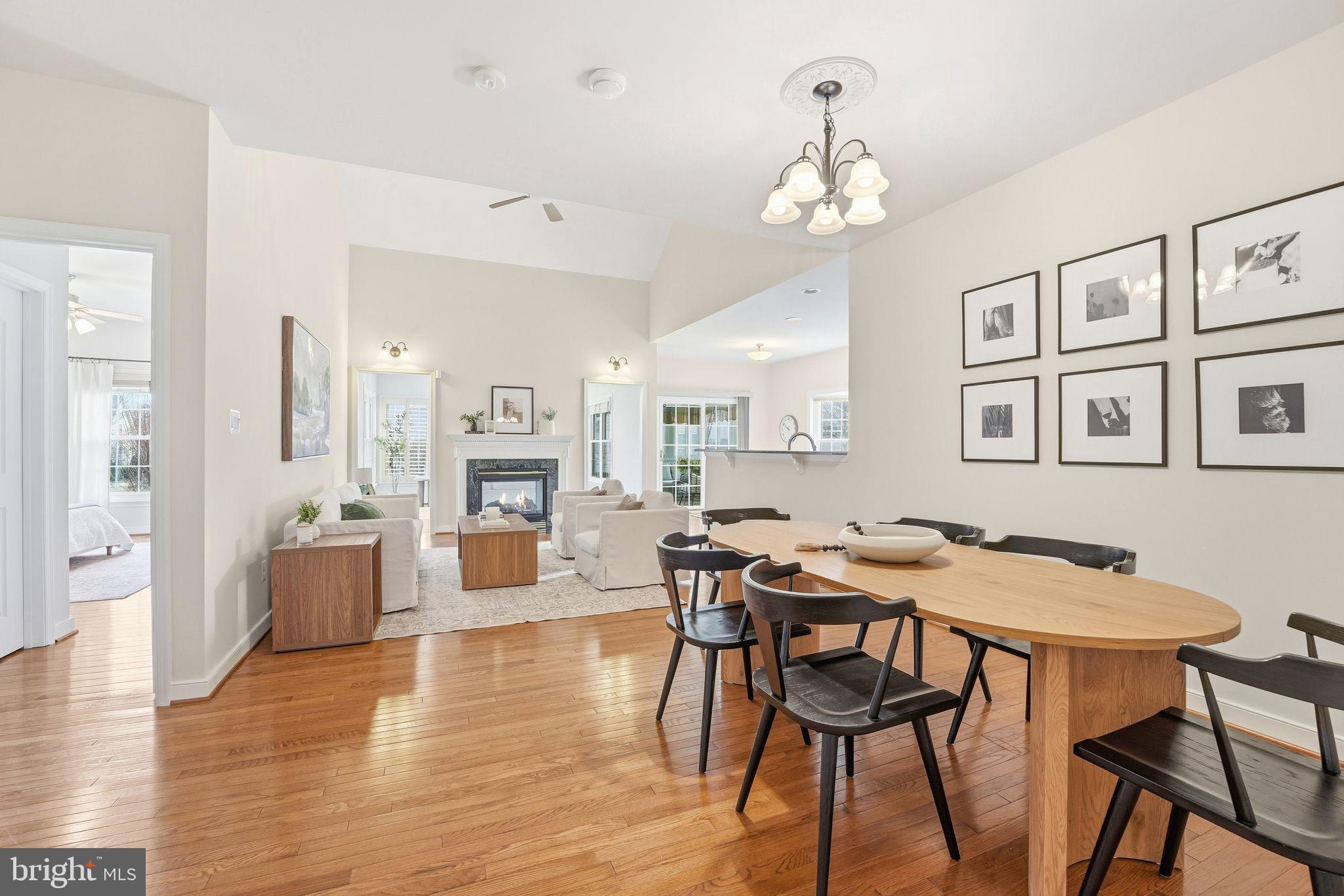 13141 Triple Crown Loop Gainesville, VA 20155 - Photo 15 of 68 a view of a dining room with furniture and wooden floor