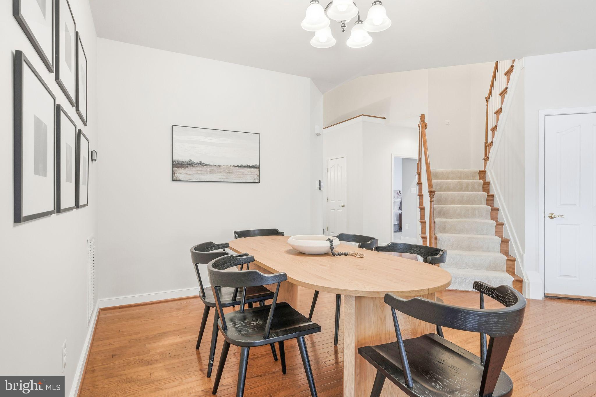 13141 Triple Crown Loop Gainesville, VA 20155 - Photo 16 of 68 a view of a dining room with furniture and wooden floor