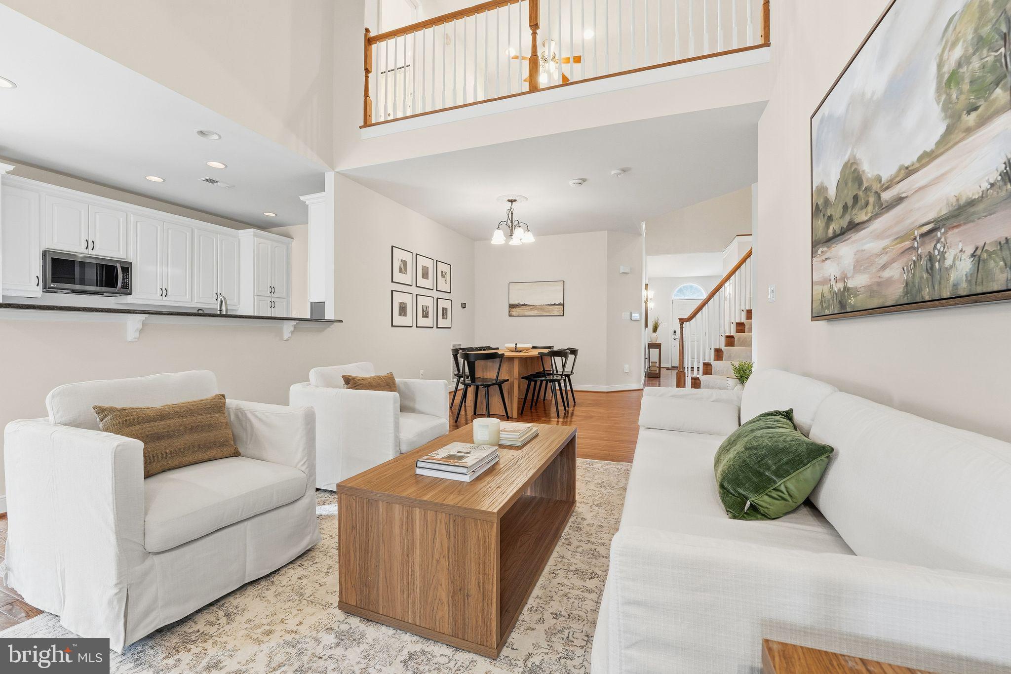 13141 Triple Crown Loop Gainesville, VA 20155 - Photo 21 of 68 a living room with furniture and a view of kitchen