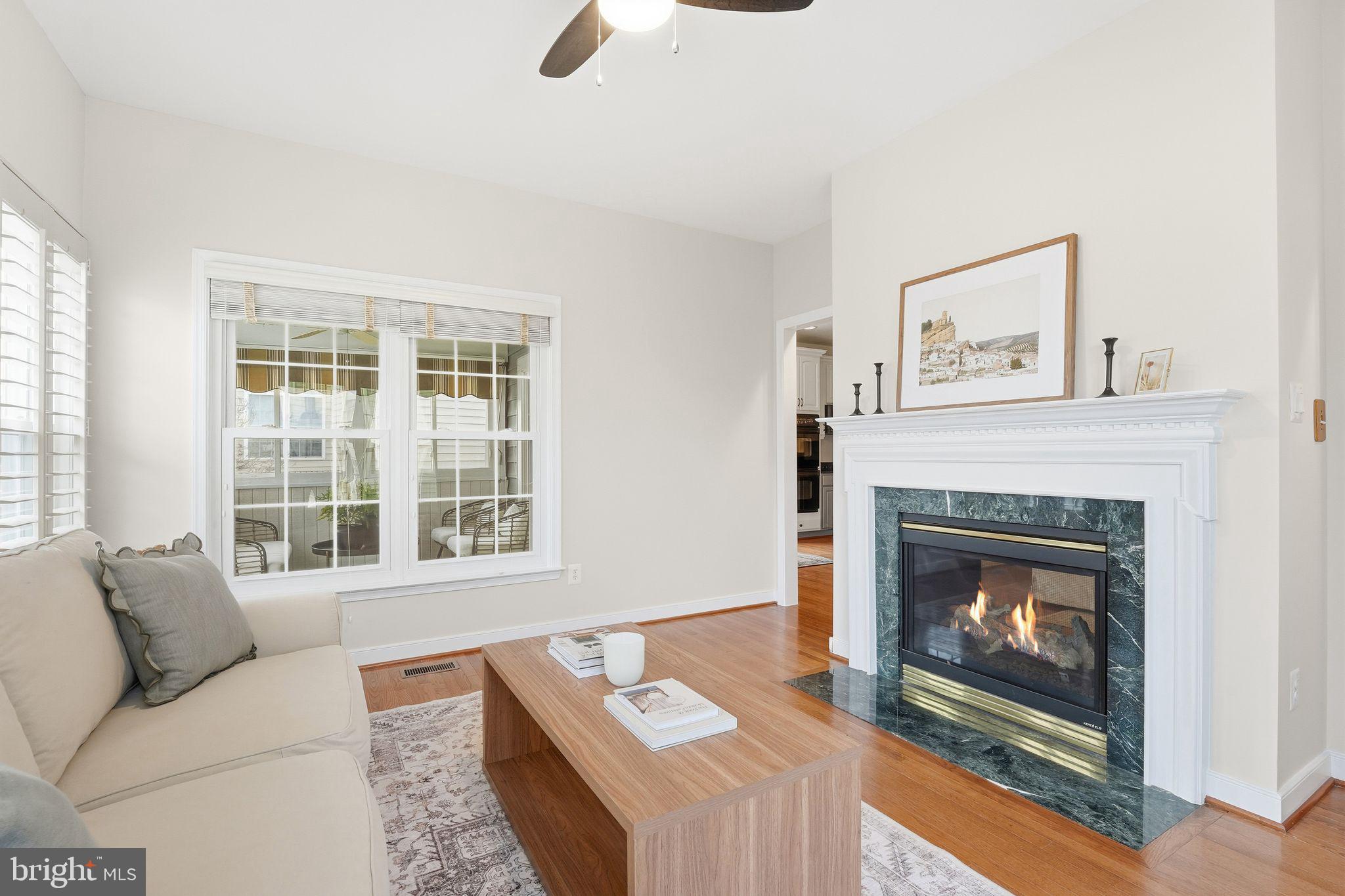13141 Triple Crown Loop Gainesville, VA 20155 - Photo 23 of 68 a living room with furniture a window and a fireplace