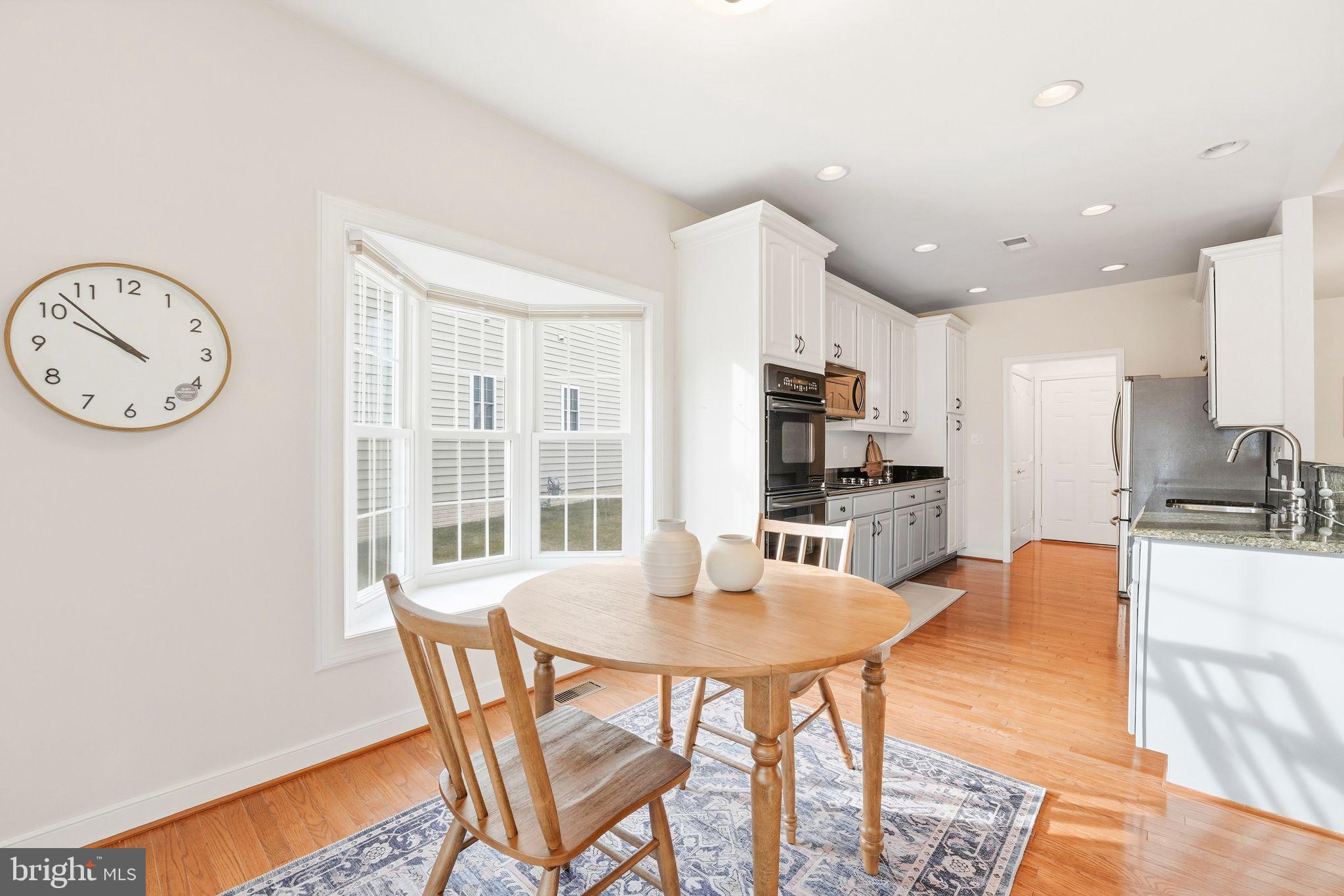13141 Triple Crown Loop Gainesville, VA 20155 - Photo 25 of 68 a view of a dining room with furniture and a kitchen