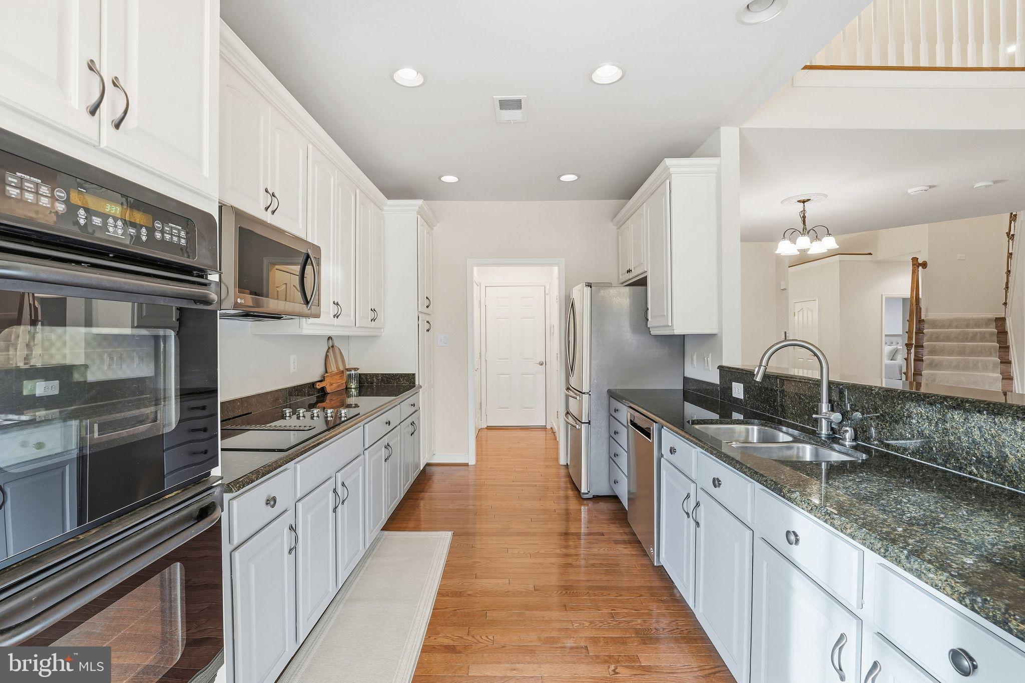 13141 Triple Crown Loop Gainesville, VA 20155 - Photo 26 of 68 a large kitchen with stainless steel appliances and a sink