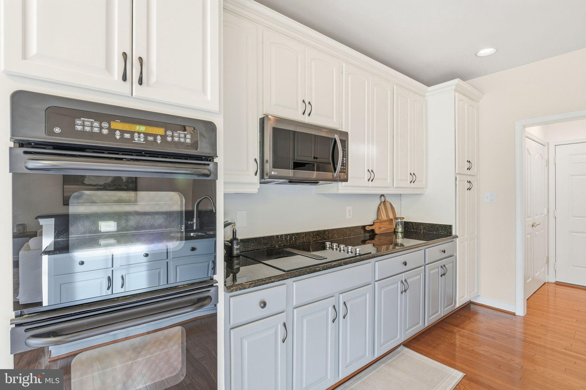 13141 Triple Crown Loop Gainesville, VA 20155 - Photo 27 of 68 a kitchen with white cabinets and appliances