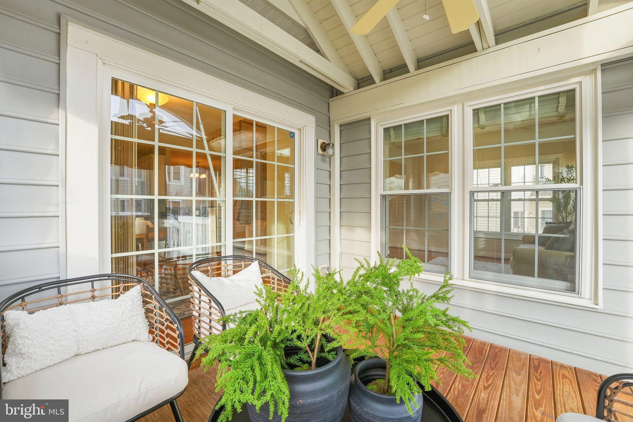 13141 Triple Crown Loop Gainesville, VA 20155 - Photo 32 of 68 a view of a porch with chairs and a potted plant