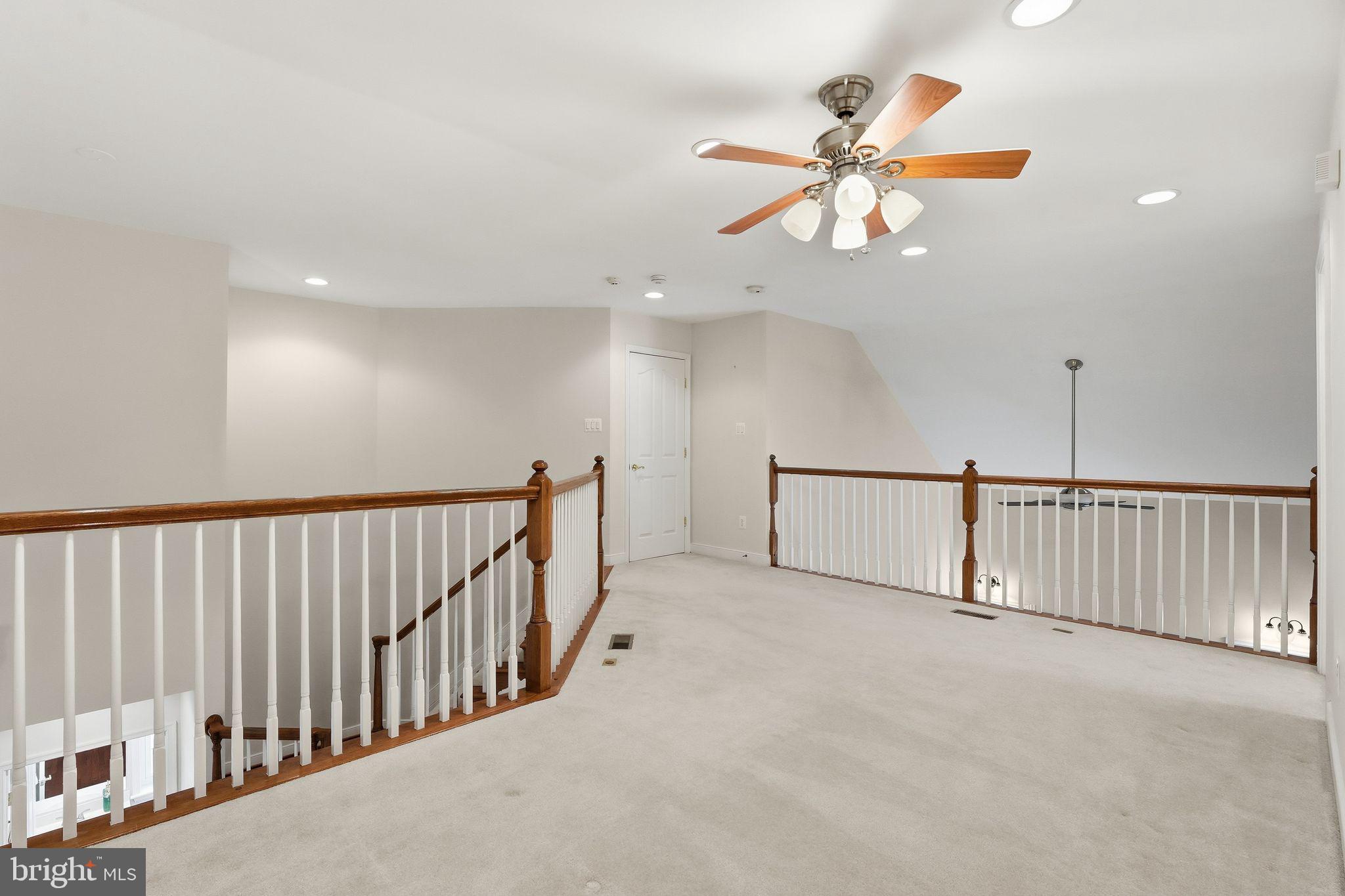 13141 Triple Crown Loop Gainesville, VA 20155 - Photo 40 of 68 a view of a hallway with a ceiling fan