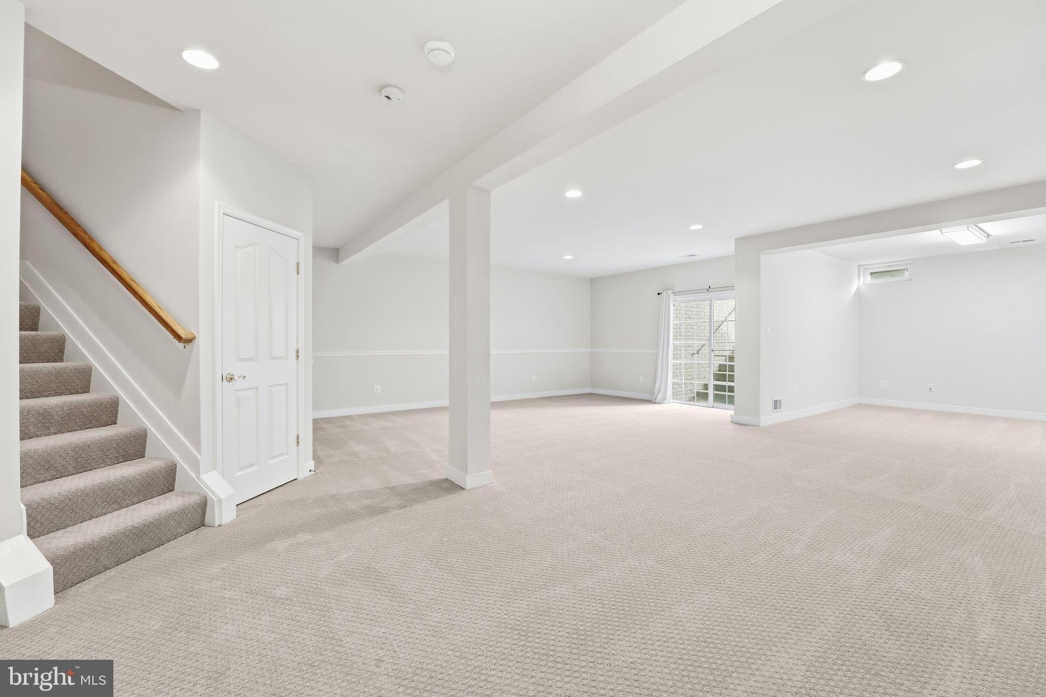 13141 Triple Crown Loop Gainesville, VA 20155 - Photo 42 of 68 a view of an empty room with wooden floor and stairs