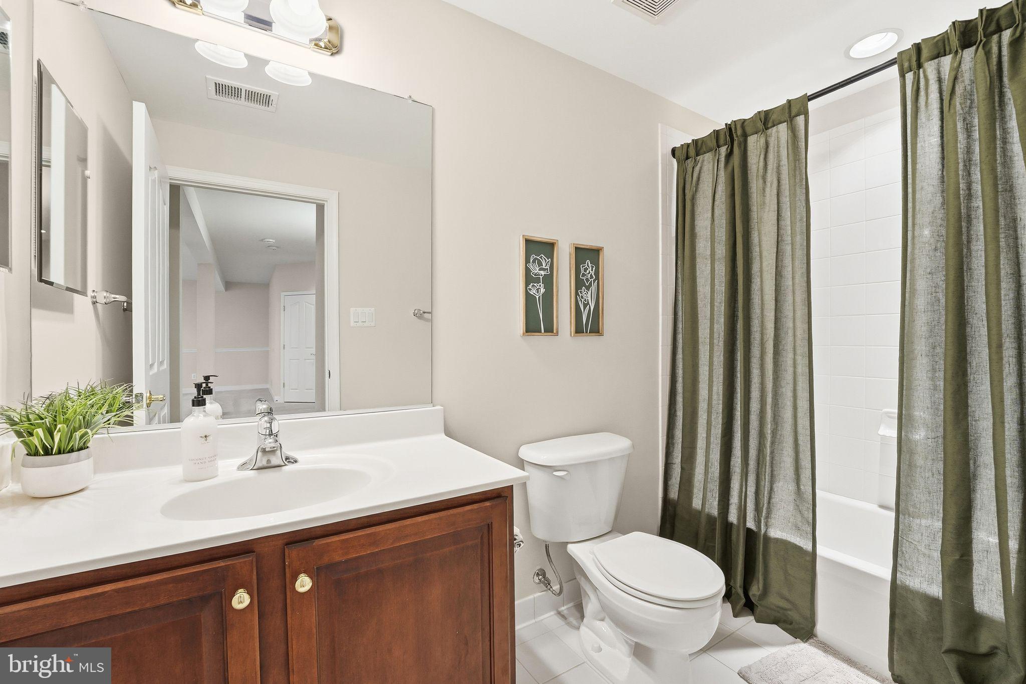 13141 Triple Crown Loop Gainesville, VA 20155 - Photo 49 of 68 a bathroom with a sink a toilet and shower