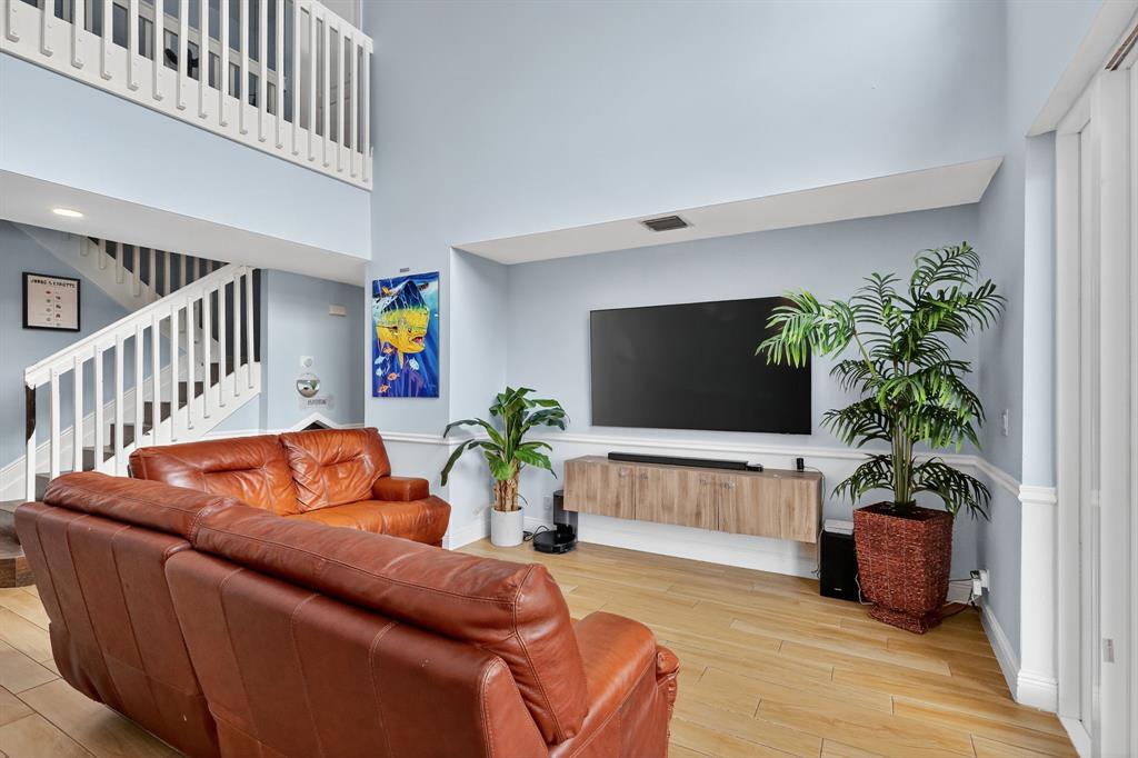 18676 Southwest 16th Street Pembroke Pines, FL 33029 - Photo 13 of 61 a living room with furniture potted plant and a wooden floor