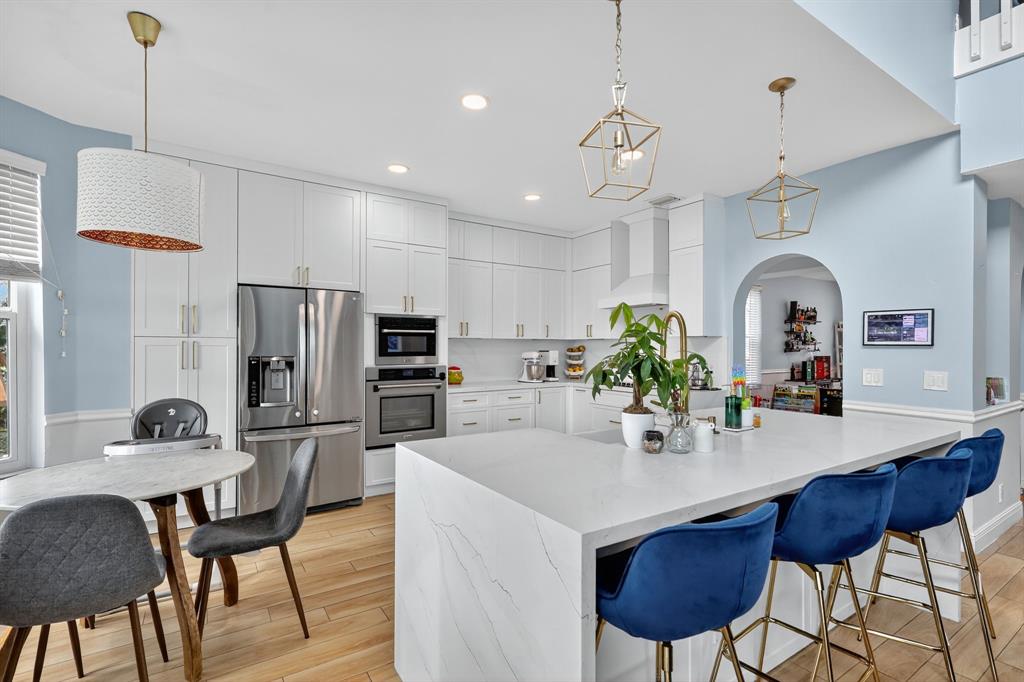 18676 Southwest 16th Street Pembroke Pines, FL 33029 - Photo 16 of 61 a kitchen with stainless steel appliances a dining table chairs and refrigerator