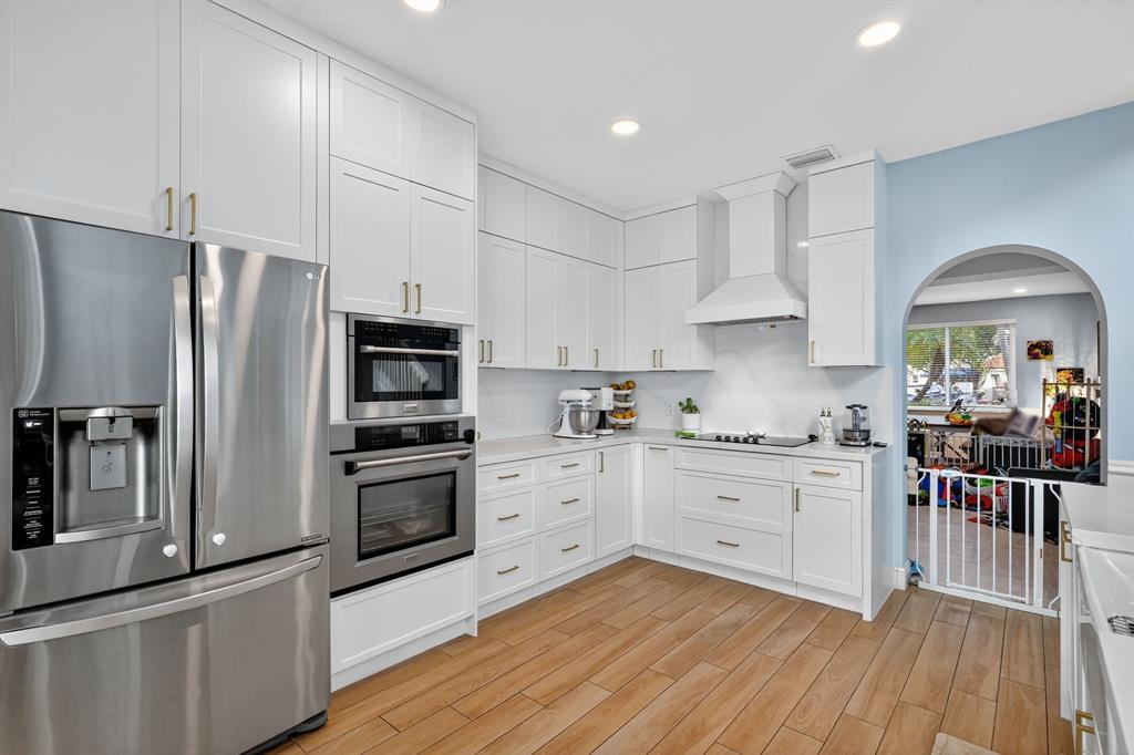 18676 Southwest 16th Street Pembroke Pines, FL 33029 - Photo 17 of 61 a kitchen with stainless steel appliances a stove a sink and a refrigerator
