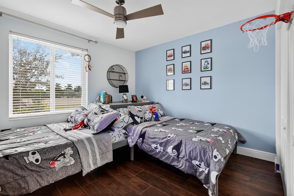 18676 Southwest 16th Street Pembroke Pines, FL 33029 - Photo 32 of 61 a bedroom with bed and a window