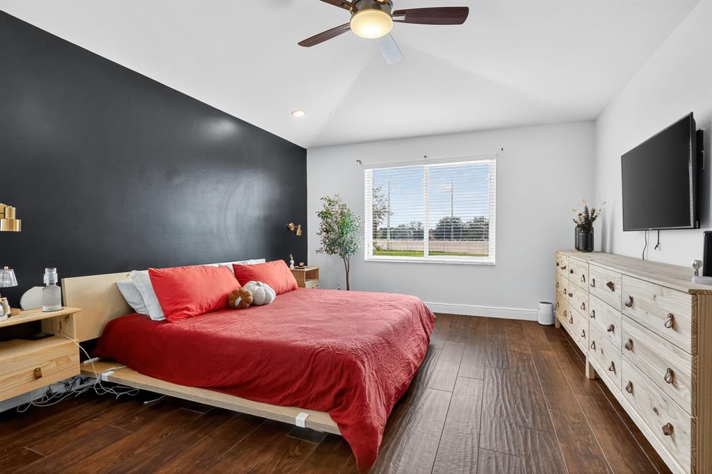 18676 Southwest 16th Street Pembroke Pines, FL 33029 - Photo 34 of 61 a bedroom with a bed and a flat screen tv